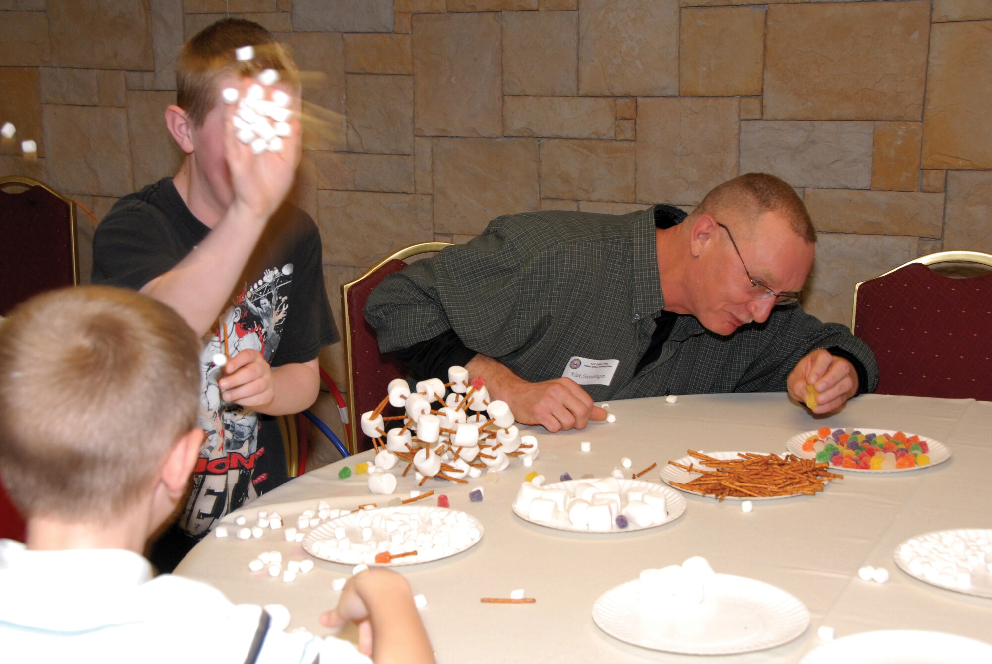 Tech. Sgt. Van Swearingin ducks during a food fight, while his son, Ryan, 10, hurls marshmallow-ammunition at the other family participating in the team building exercise at the Yellow Ribbon Reintegration event March 5, 2010. Sergeant Swearingin is part of the 442nd Security Forces Squadron, which is part of the 442nd Fighter Wing, an Air Force Reserve unit at Whiteman Air Force Base, Mo. (U.S. Air Force photo/Senior Airman Danielle Wolf)