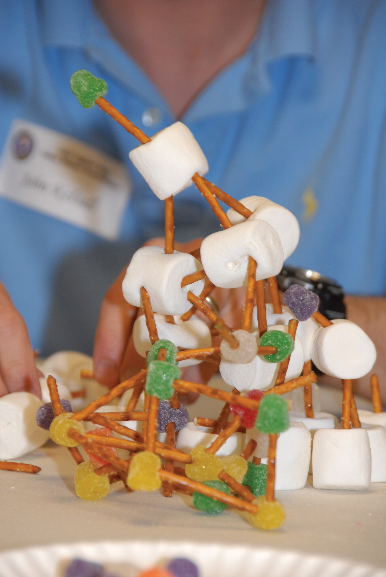 Tech. Sgt. John Kelsall's family works together to create a structure made of marshmallows, pretzels and gum drops during the family team building exercise taught by the military and family life consultants at the Yellow Ribbon Reintegration event March 5, 2010. Sergeant Kelsall is part of the 442nd Security Forces Squadron, which is part of the 442nd Fighter Wing, an Air Force Reserve unit at Whiteman Air Force Base, Mo. (U.S. Air Force photo/Senior Airman Danielle Wolf)