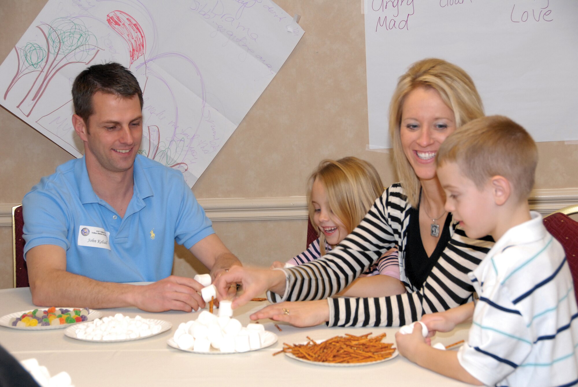 Tech. Sgt. John Kelsall, his wife DeAnna, and children Olivia and Cole work together to create a structure made out of snacks during a family team building exercise during the Yellow Ribbon Reintegration Event March 5, 2010. Sergeant Kelsall is part of the 442nd Security Forces Squadron, which is part of the 442nd Fighter Wing, an Air Force Reserve unit at Whiteman Air Force Base, Mo. (U.S. Air Force photo/Senior Airman Danielle Wolf)