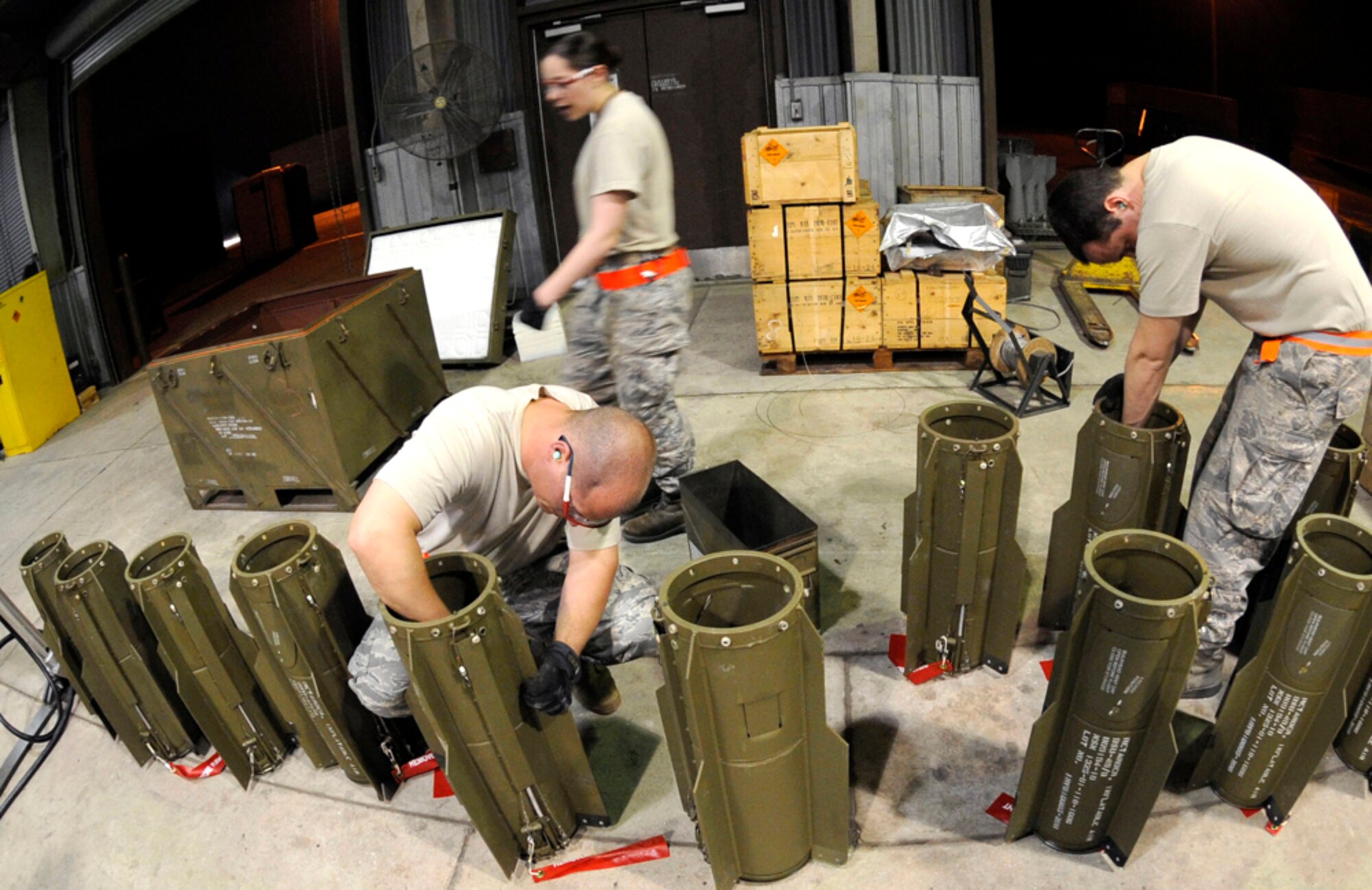 Staff Sgts. Brandon Jones and Wesley Cummins prepare BSU-49 fin kits before installing them on bomb bodies during the Combat Ammunitions Production Exercise May 25, 2010, at Osan Air Base, South Korea. Sergeants Jones and Cummins are munitions maintainers from the 51st Munitions Squadron. CAPEX is a non-rated exercise held once a year in the Pacific Air Forces region. (U.S. Air Force photo/Staff Sgt. Stephenie Wade) 