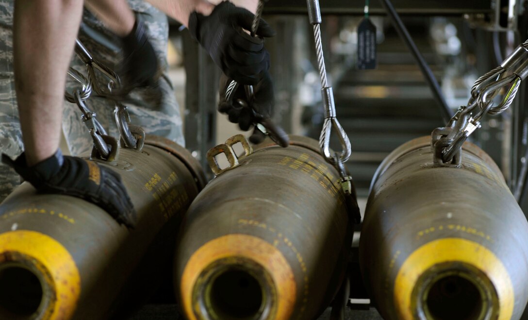Senior Airmen Travis Talley and Derek White attach hooks to BLU-109 munitions before loading them onto a rolling rack to be assembled during the Combat Ammunitions Production Exercise May 25, 2010, at Osan Air Base, South Korea. Airman Talley is a munitions maintainer from the 51st Munitions Squadron. Airman White is from the 35th Munitions Squadron at Misawa Air Base, Japan. CAPEX is a non-rated exercise held once a year in the Pacific Air Forces region. It provides training on non-nuclear reserve munitions production in integrated tasks orders and planning. (U.S. Air Force photo/Staff Sgt. Stephenie Wade)