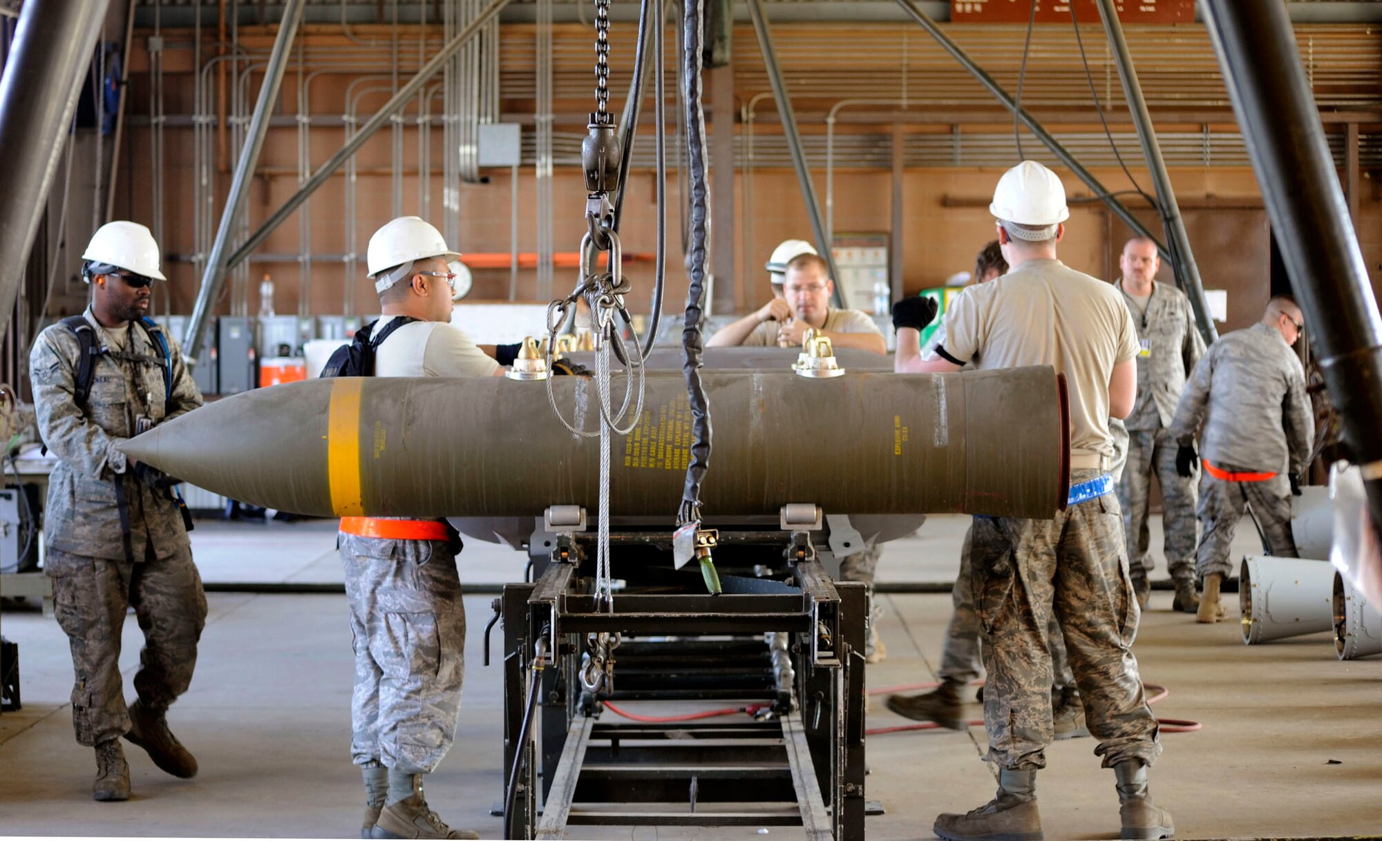 Multiple munitions maintainers from around the Pacific assemble BLU-109 munitions in the small bomb pad during the Combat Ammunitions Production Exercise May 25, 2010, at Osan Air Base, South Korea. CAPEX is a non-rated exercise held once a year in the Pacific Air Forces region. It provides training on non-nuclear reserve munitions production in integrated tasks orders and planning. (U.S. Air Force photo/Staff Sgt. Stephenie Wade) 
