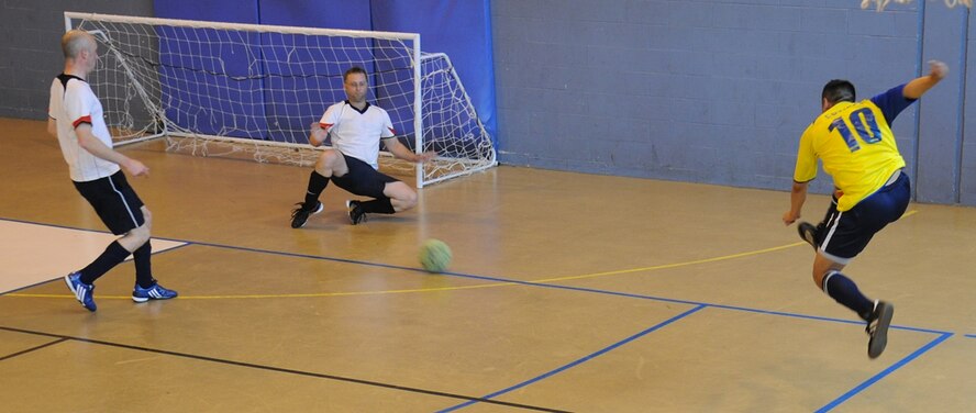 Jonathan Cardenas (10), the 352nd Maintenance Squadron striker blasts a shot at Barry King, the 100th Civil Engineer Squadron goalkeeper, during the Intramural Soccer Championships at the Northside Fitness Center, May 27. (U.S. Air Force photo/ Staff Sgt. Jerry Fleshman)