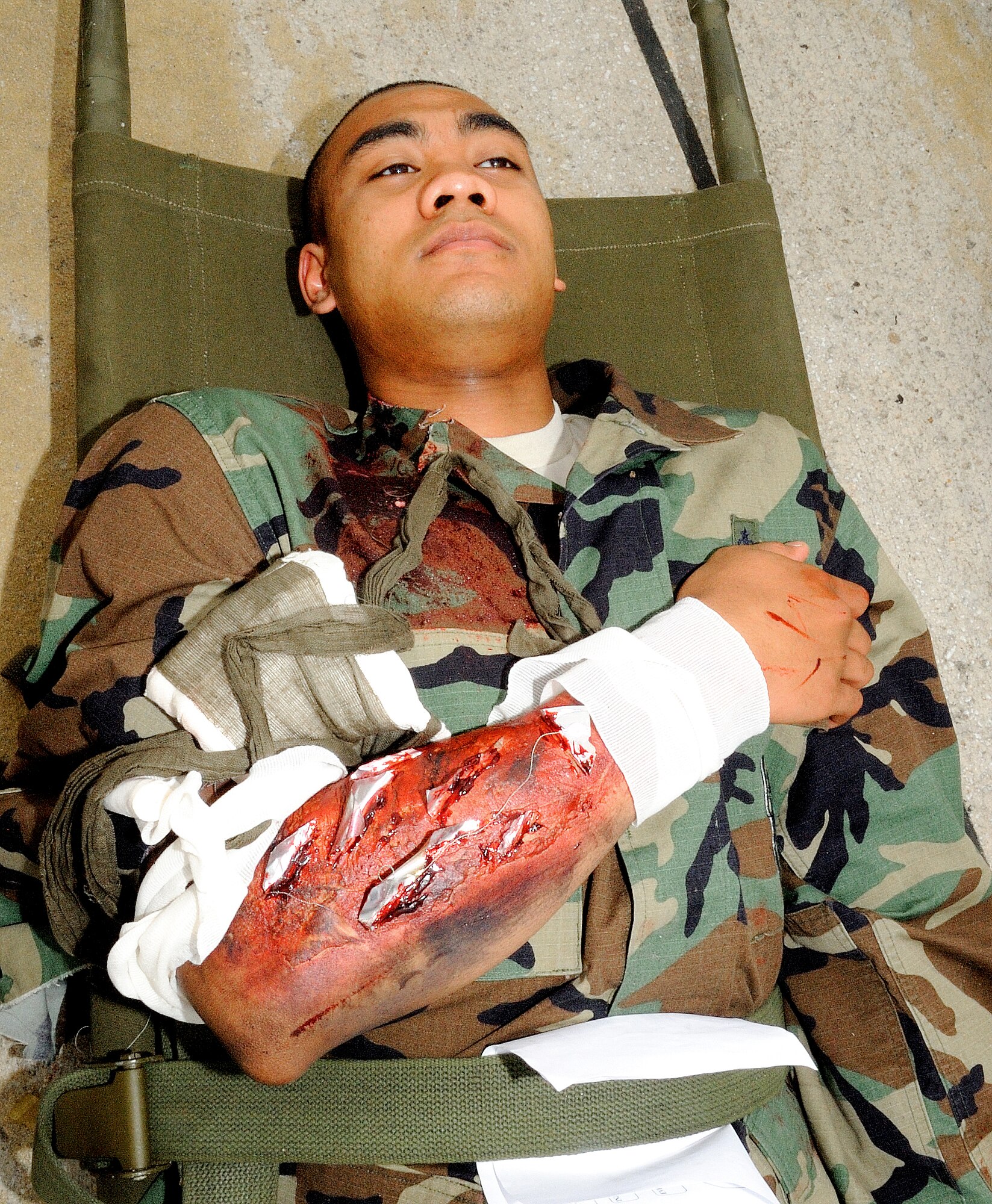 SPANGDAHLEM AIR BASE, Germany – Airman 1st Class Delnard Toney, 52nd Force Support Squadron customer service technician, acts as a third-degree-burn moulage victim during Operation Saber Crown 10-8 May 27. Members of the 52nd Fighter Wing participated in the exercise to evaluate the wing’s ability to survive and operate in a chemical, biological, radiological, nuclear and explosive environment. (U.S. Air Force photo/Airman 1st Class Nick Wilson)