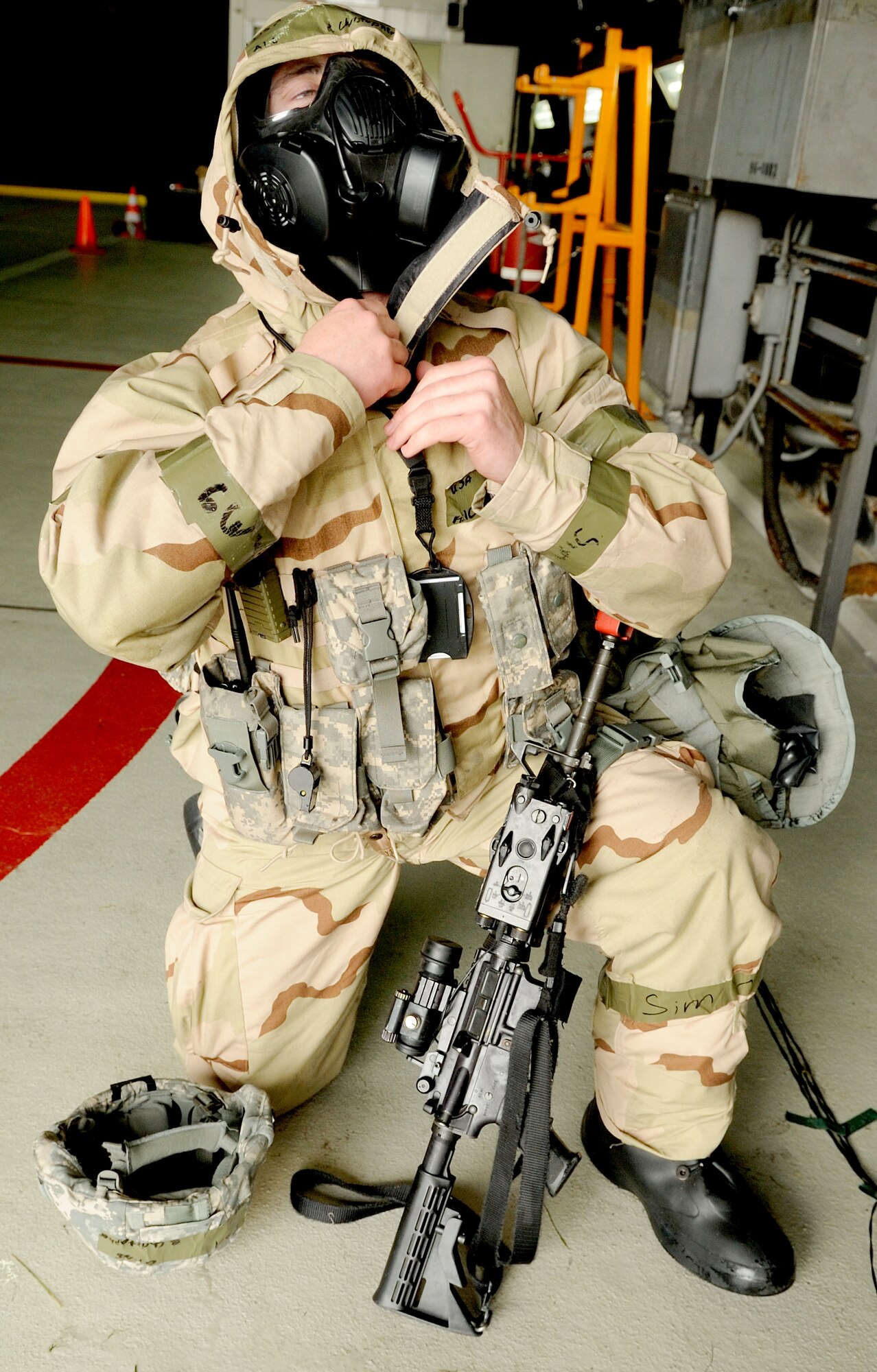 SPANGDAHLEM AIR BASE, Germany – Staff Sgt. Christopher Blake, 52nd Security Forces Squadron police services craftsman, dons mission oriented protective posture gear during Operation Saber Crown 10-8 May 26. Members of the 52nd Fighter Wing participated in the exercise to evaluate the wing’s ability to survive and operate in a chemical, biological, radiological, nuclear and explosive environment. (U.S. Air Force photo/Airman 1st Class Nick Wilson)