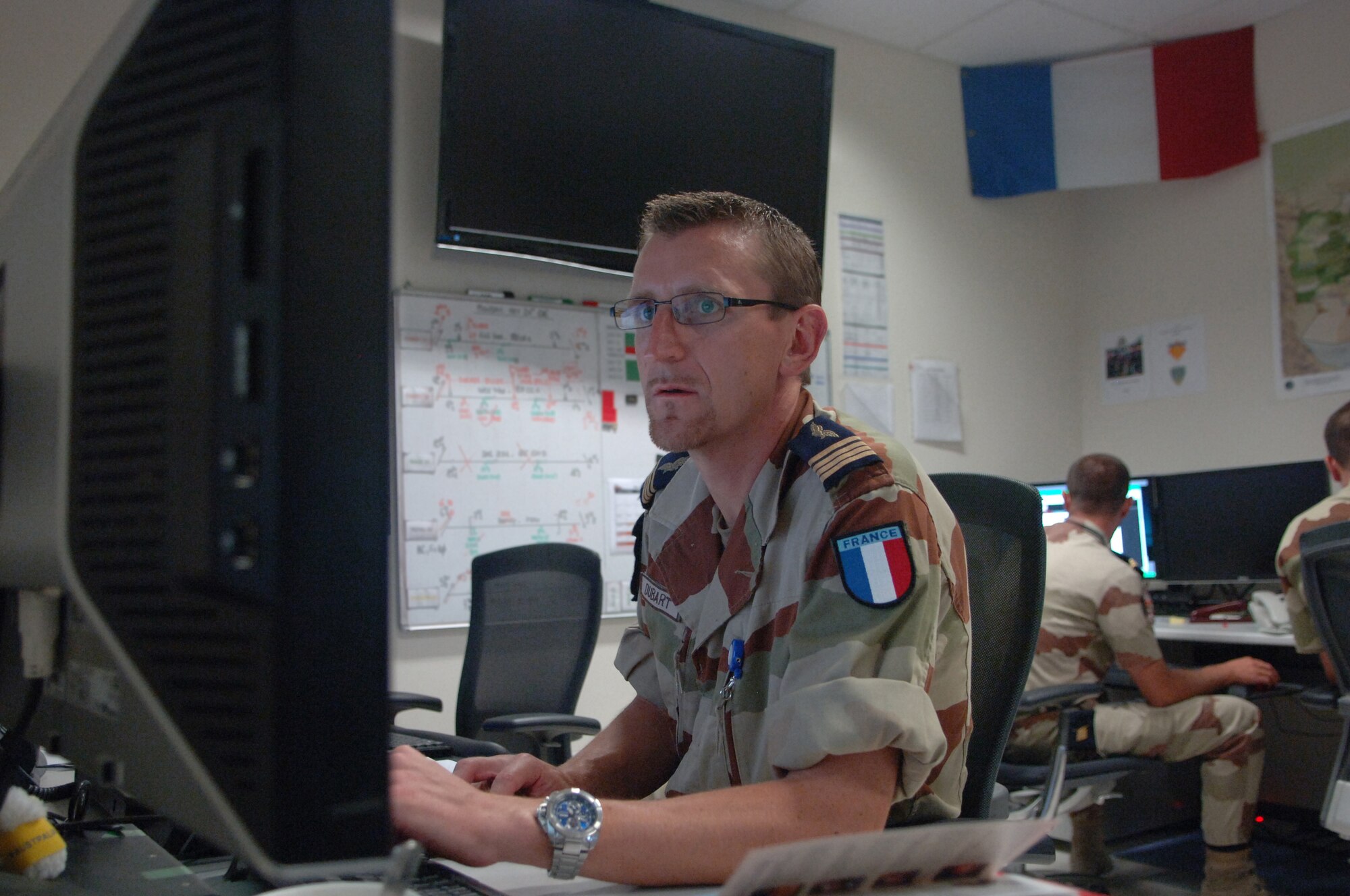 Maj. Christophe Dubart, 609th Combined Air and Operations Center French Air Force Detachment deputy officer, prepares the next day's mission plan at a non-disclosed Southwest Asia location May 24, 2010. (U.S. Air Force photo by Senior Airman Kasey Zickmund)[RELEASED]