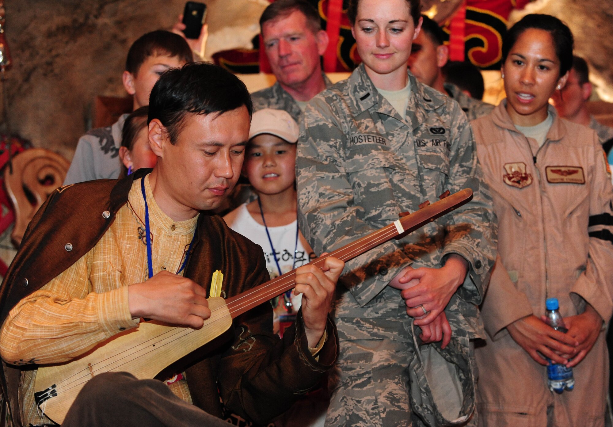 Asylbek Nasirdinov, a famous Kyrgyz musician, plays a Koomuz during the Yurt grand opening celebration at the Transit Center at Manas, Kyrgyzstan, May 28, 2010. Airmen from the Transit Center at Manas embraced the "spirit of Kyrgyzstan" by celebrating this most recent building here, which symbolizes the friendship between the United States and its host nation here. (U.S. Air Force photo/ Senior Airman Nichelle Anderson/ released)