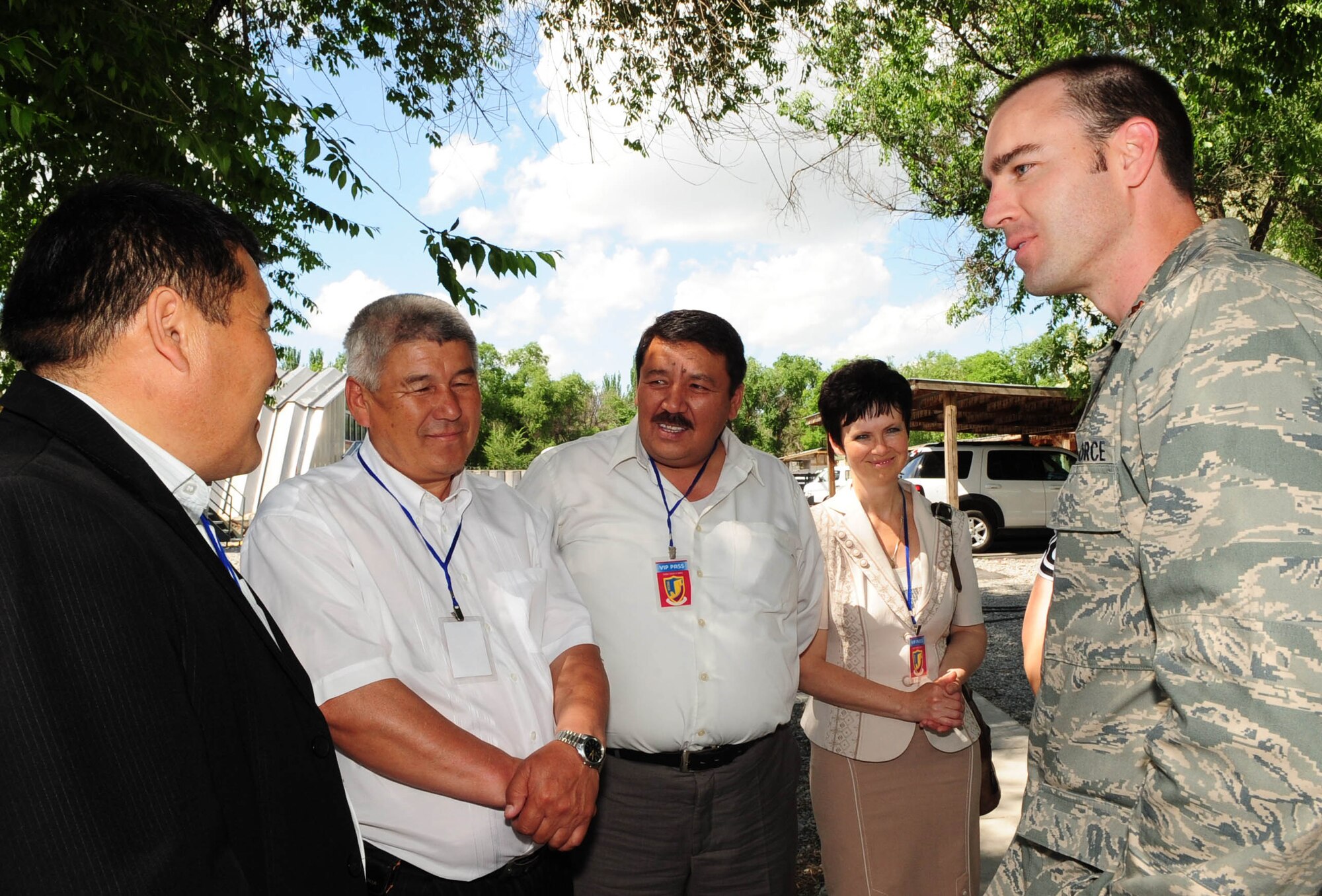 Maj. Shane Hamacher, 376th Air Expeditionary Wing coalition coordinator linguist, speaks with community leaders during the grand opening of a newly-constructed Yurt at the Transit Center at Manas, Kyrgyzstan, May 28, 2010. Airmen embraced the "spirit of Kyrgyzstan" by celebrating the most recent building here: a Yurt, which is the traditional nomadic Kyrgyz home and a structure which now symbolizes friendship between the United States and its host nation here. (U.S. Air Force photo/ Senior Airman Nichelle Anderson/ released)