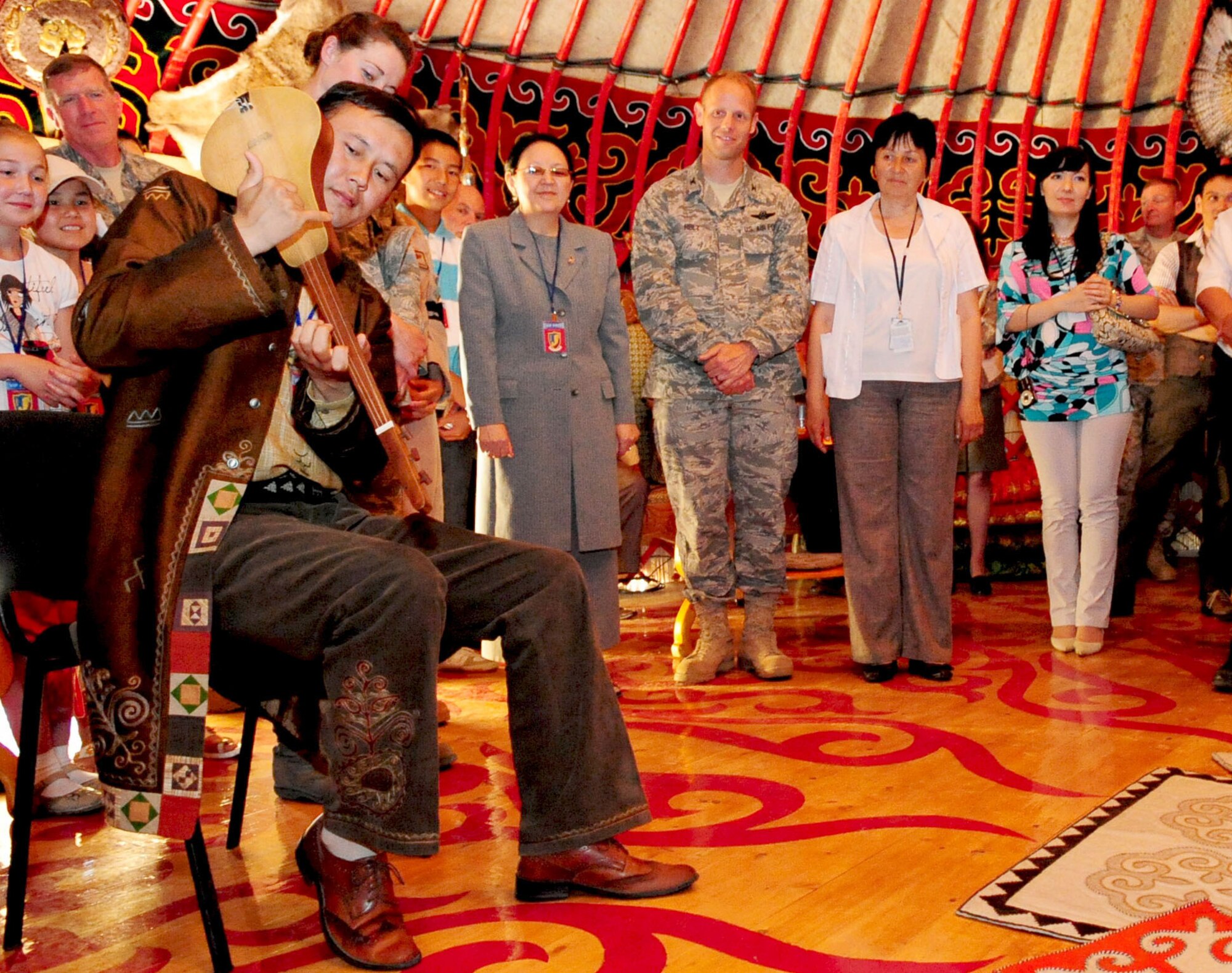 Asylbek Nasirdinov, a famous Kyrgyz musician, plays a Koomuz during the Yurt grand opening celebration at the Transit Center at Manas, Kyrgyzstan, May 28, 2010. Airmen from the Transit Center at Manas embraced the "spirit of Kyrgyzstan" by celebrating this most recent building here, which symbolizes the friendship between the United States and its host nation here. (U.S. Air Force photo/ Senior Airman Nichelle Anderson/ released)