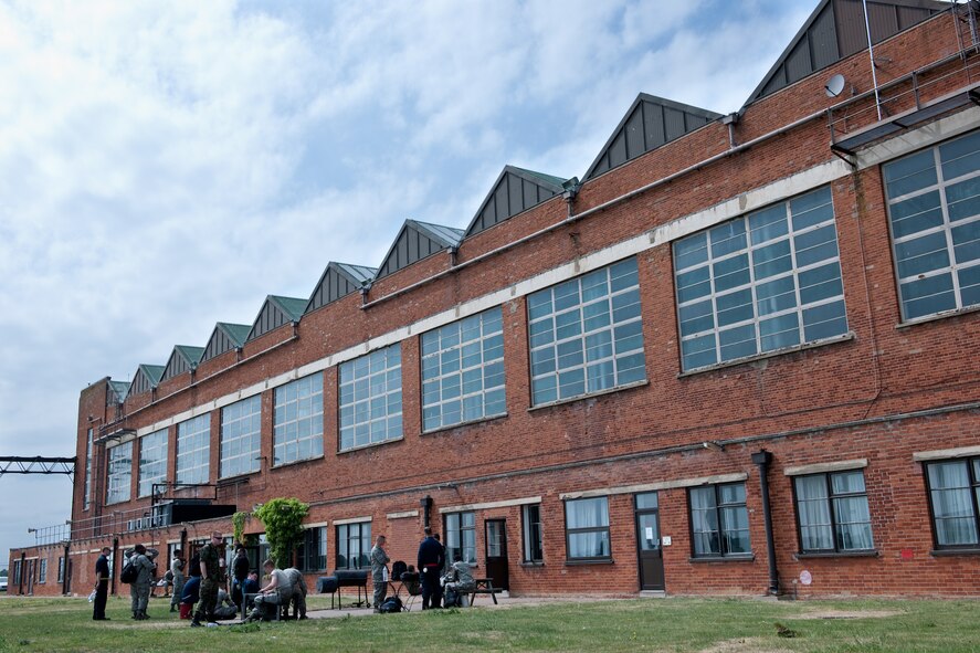 Airmen from the 48th Aircraft Maintenance Squadron relax after a hard day of work in front of their temporary home at RAF Mildenhall May 25. The maintainers will be working out of the tanker base until repairs on their home runway at RAF Lakenheath are finished. The maintenance Airmen are working out of RAF Mildenhall temporarily while their home runway at RAF Lakenheath, England, is being repaired. (U.S. Air Force photo/Tech. Sgt. Nathan Gallahan)