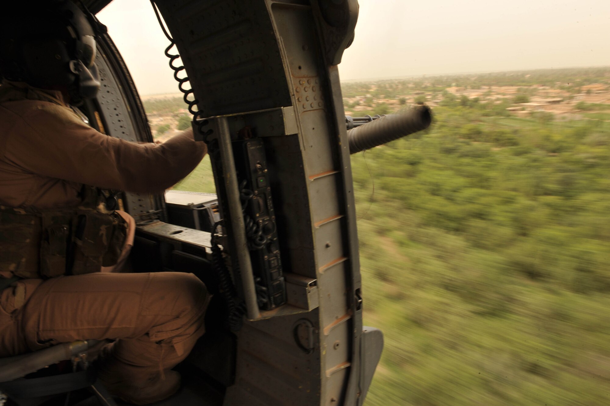 U.S. Air Force Staff Sgt. Dave Lamica, a flight engineer assigned to the 64th Expeditionary Rescue Squadron, scans the Iraqi sky from the back of an HH-60 Pave Hawk helicopter during a training flight May 15, 2010, near Joint Base Balad, Iraq.  (U.S. Air Force photo/Staff Sgt. Quinton Russ/released)