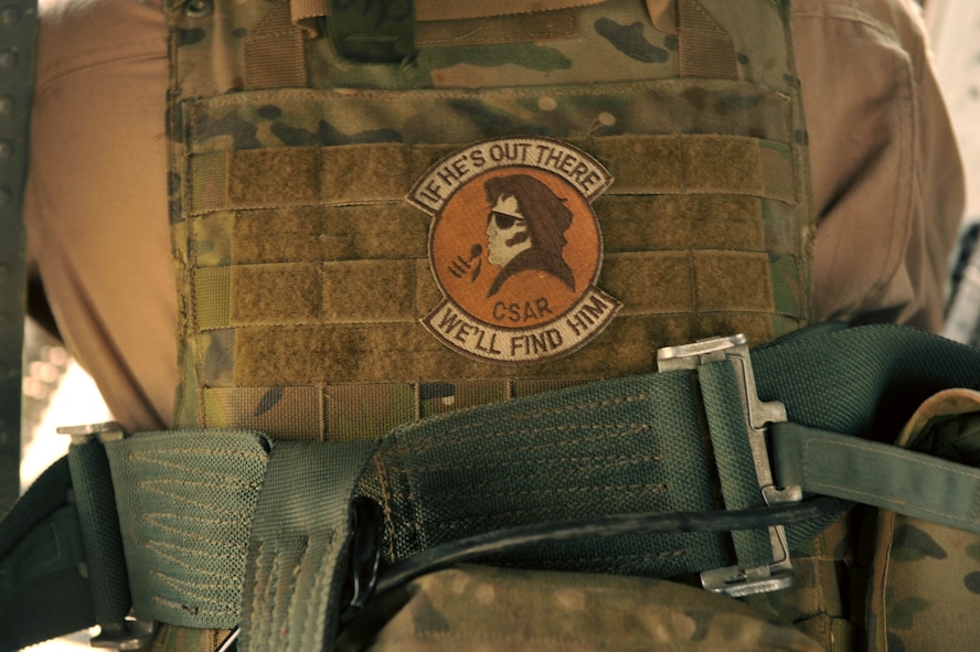 U.S. Air Force Senior Airman Joseph Arriza, an aerial gunner assigned to the 64th Expeditionary Rescue Squadron, wears a morale patch reflecting the squadron's personnel-recovery mission during a training flight May 15, 2010, near Joint Base Balad, Iraq.  (U.S. Air Force photo/Staff Sgt. Quinton Russ/released)