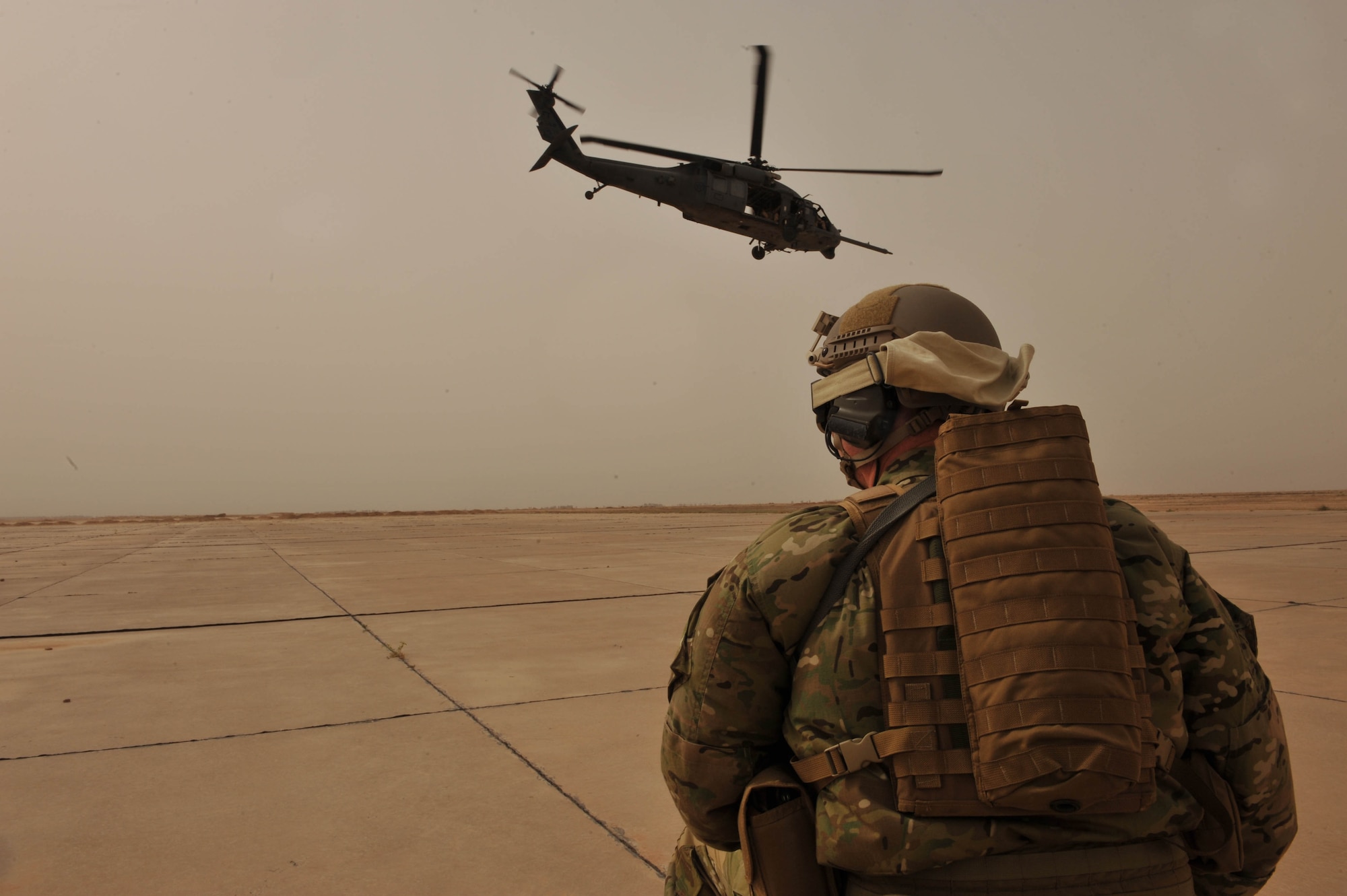 U.S. Air Force Master Sgt. Shawn Studer, Survival, Evasion, Resistance and Escape specialist assigned to the 64th Expeditionary Rescue Squadron, watches an HH-60 Pave Hawk helicopter take off during a training flight, May 15, 2010, at Joint Base Balad, Iraq.   (U.S. Air Force photo/Staff Sgt Quinton Russ/released)