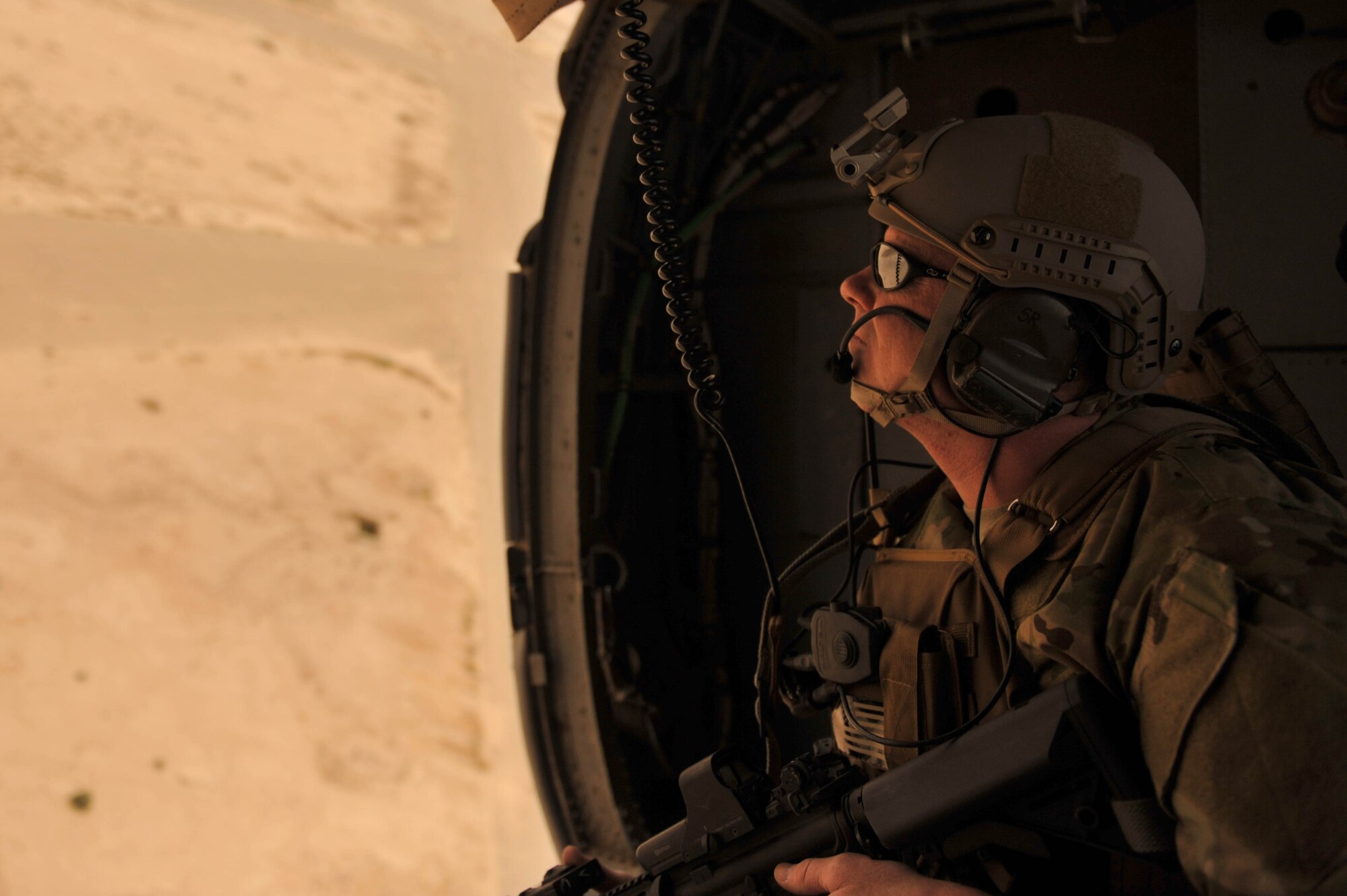 U.S. Air Force Master Sgt. Shawn Studer, survival, evasion, resistance and escape  specialist assigned to the 64th Expeditionary Rescue Squadron, scans the Iraqi skies from the back of an HH-60 Pave Hawk during a training flight, May 15, 2010, near Joint Base Balad, Iraq.  (U.S. Air Force photo/Staff Sgt. Quinton Russ/released)