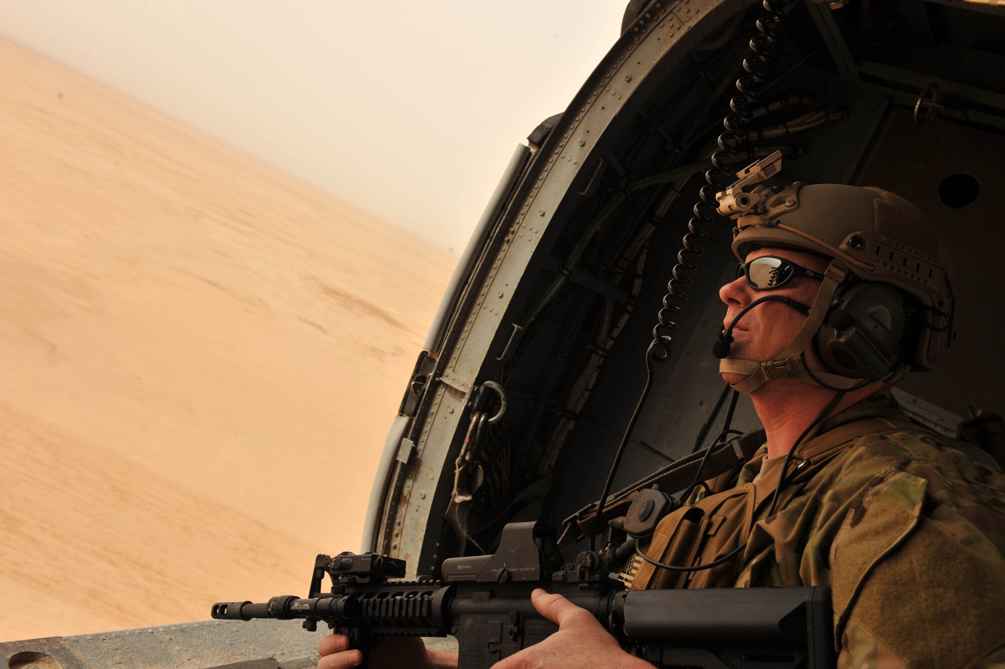 U.S. Air Force Master Sgt. Shawn Studer, a survival, evasion, resistance and escape specialist assigned to the 64th Expeditionary Rescue Squadron, scans the Iraqi skies from the back of an HH-60 Pave Hawk helicopter during a training flight May 15, 2010, near Joint Base Balad, Iraq.  (U.S. Air Force photo/Staff Sgt. Quinton Russ/released)