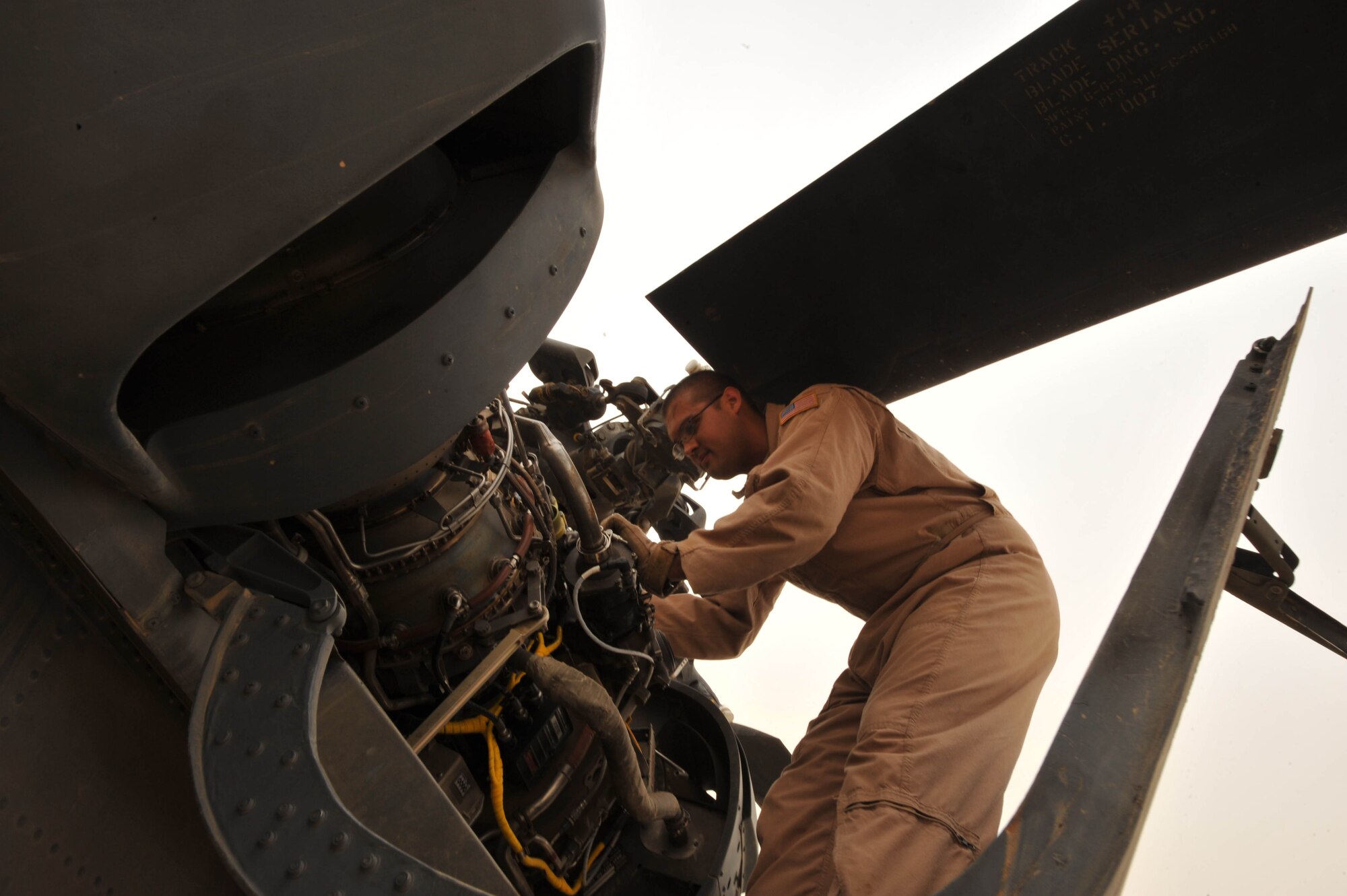 U.S. Air Force Staff Sgt. Dave Lamica, a flight engineer assigned to the 64th Expeditionary Rescue Squadron, conducts preflight checks on an HH-60 Pave Hawk helicopter before a training flight, May 15, 2010, at Joint Base Balad, Iraq.  (U.S. Air Force photo/Staff Sgt. Quinton Russ/released)