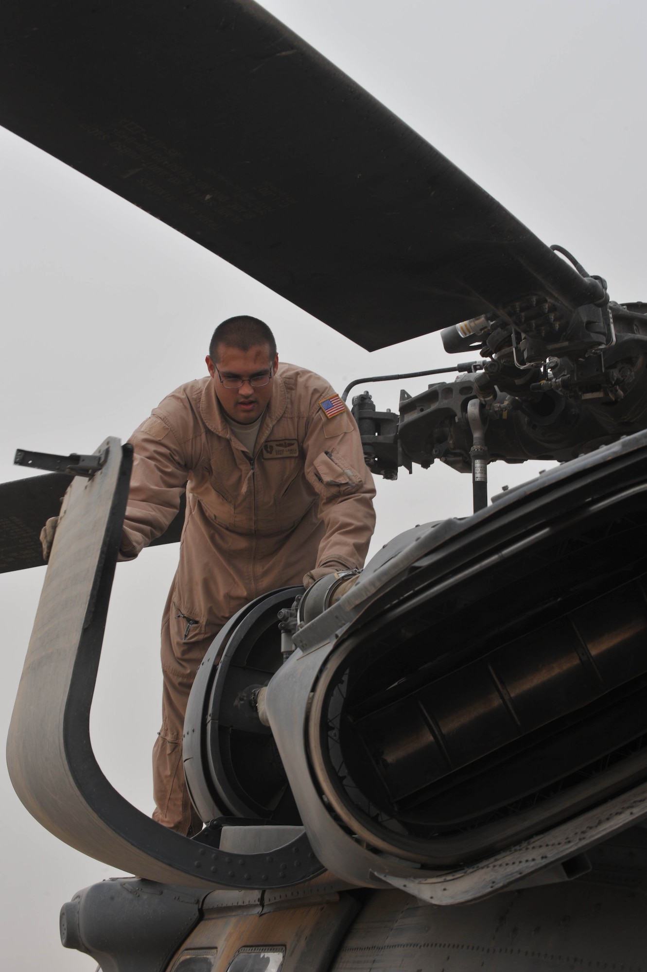 U.S. Air Force Staff Sgt. Dave Lamica, a flight engineer assigned to the 64th Expeditionary Rescue Squadron, preflights an HH-60 Pave Hawk helicopter before a training flight at Joint Base Balad, Iraq, May 15, 2010. Aircrew members train to remain proficient and current on all aspects of the rescue mission.  (U.S. Air Force photo/Staff Sgt. Quinton Russ/released)