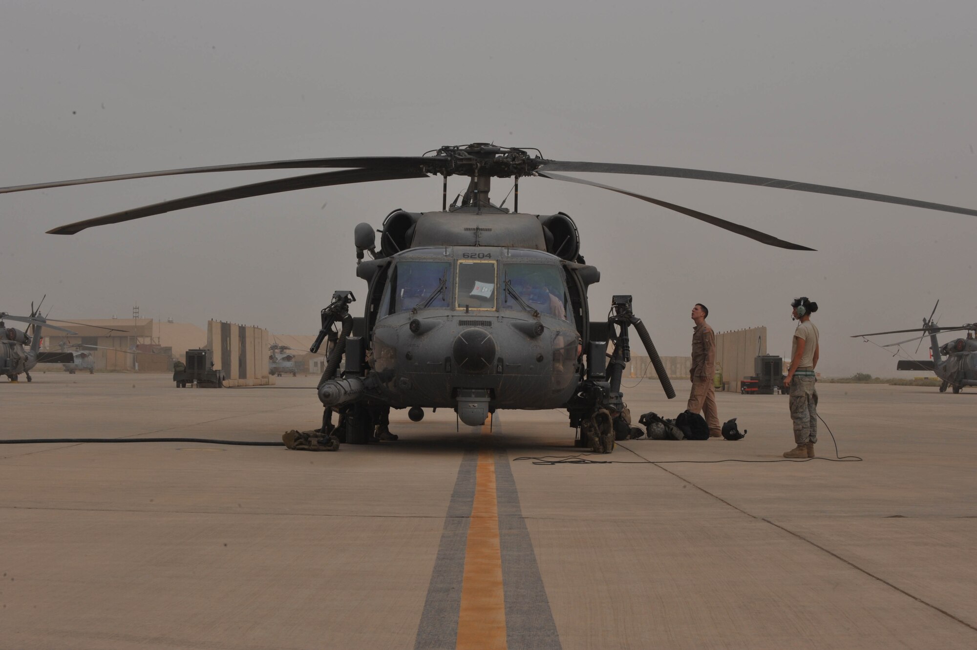 A ground-maintenance crew prepares an HH-60 Pave Hawk helicopter for flight May 15, 2010. The crew is assigned to the 64th Expeditionary Rescue Squadron, Joint Base Balad, Iraq.  (U.S. Air Force photo/Staff Sgt. Quinton Russ/released)