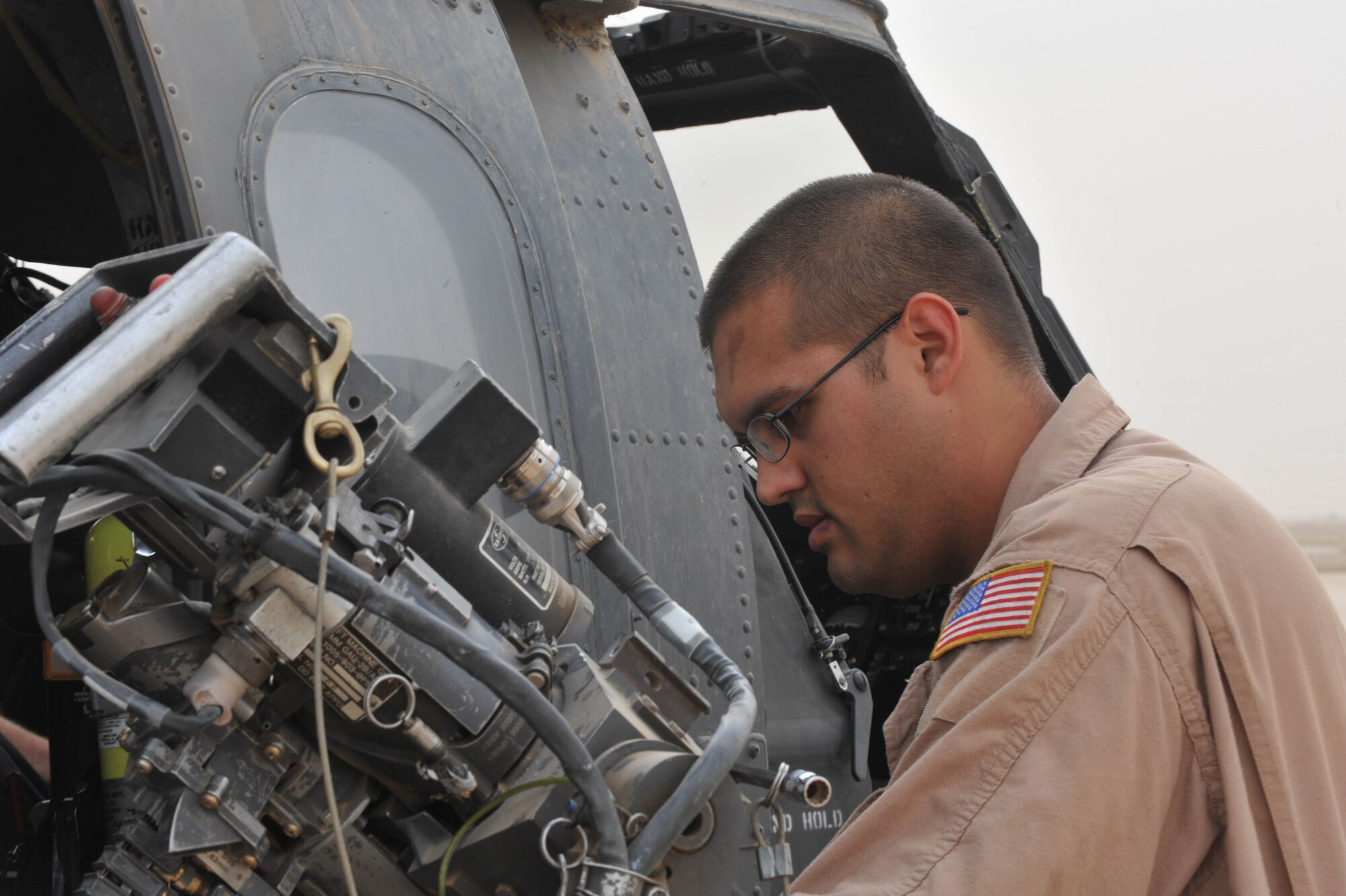 U.S. Air Force Staff Sgt. Dave Lamica, a flight engineer assigned to the 64th Espeditionary Resque Squadron, prepares a GAU-2 mini-gun before a training flight May 15, 2010, at Joint Base Balad, Iraq.  (U.S. Air Force photo/Staff Sgt. Quinton Russ/released)