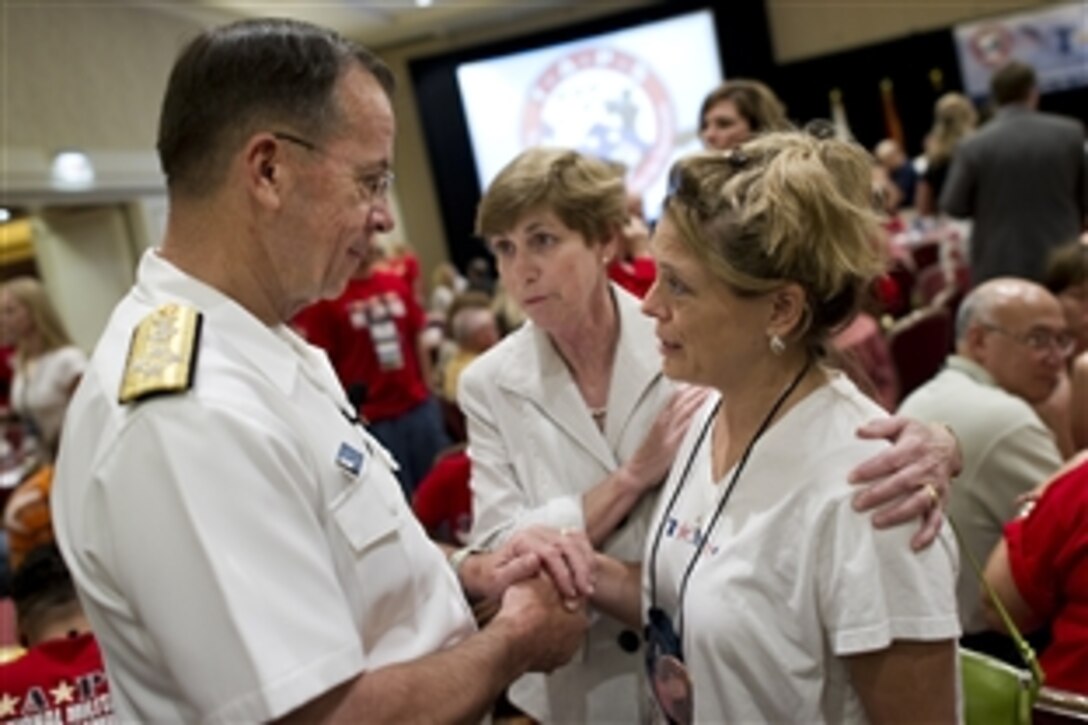 U.S. Navy Adm. Mike Mullen, chairman of the Joint Chiefs of Staff, and his wife, Deborah, talk with Elizabeth Church at the Tragedy Assistance Program for Survivors Military Survivor Seminar and Good Grief Camp opening in Crystal City, Va., May 28, 2010. The sessions provide information to spouses and children of fallen servicemembers to help them heal and cope with life after loss.