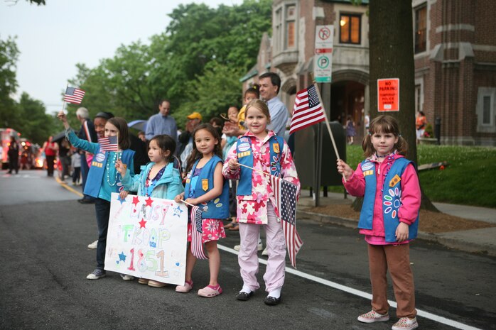 Marines from Special Purpose Marine Air Ground Task Force New York were greeted by flag-waving families as they marched in the Larchmont Memorial Parade, May 27, 2010. More than 3,000 Marines, Sailors and Coast Guardsmen will be in the area participating in community outreach events and equipment demonstrations. This is the 26th year New York City has hosted the sea services for Fleet Week.
