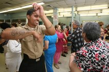 NEW YORK --  Several service members from the amphibious assault ship USS Iwo Jima, and Special Purpose Marine Air-Ground Task Force New York, visited with some of New York's senior citizens at the Jewish Association for Services for the Aged program's Williamsburg Senior Center in Brooklyn, N.Y., May 28, 2010, as part of Fleet Week New York's community outreach projects.ore than 3,000 Marines, Sailors and Coast Guardsmen are in the area participating in community outreach events and equipment demonstrations. This is the 26th year New York City has hosted the sea services for Fleet Week.