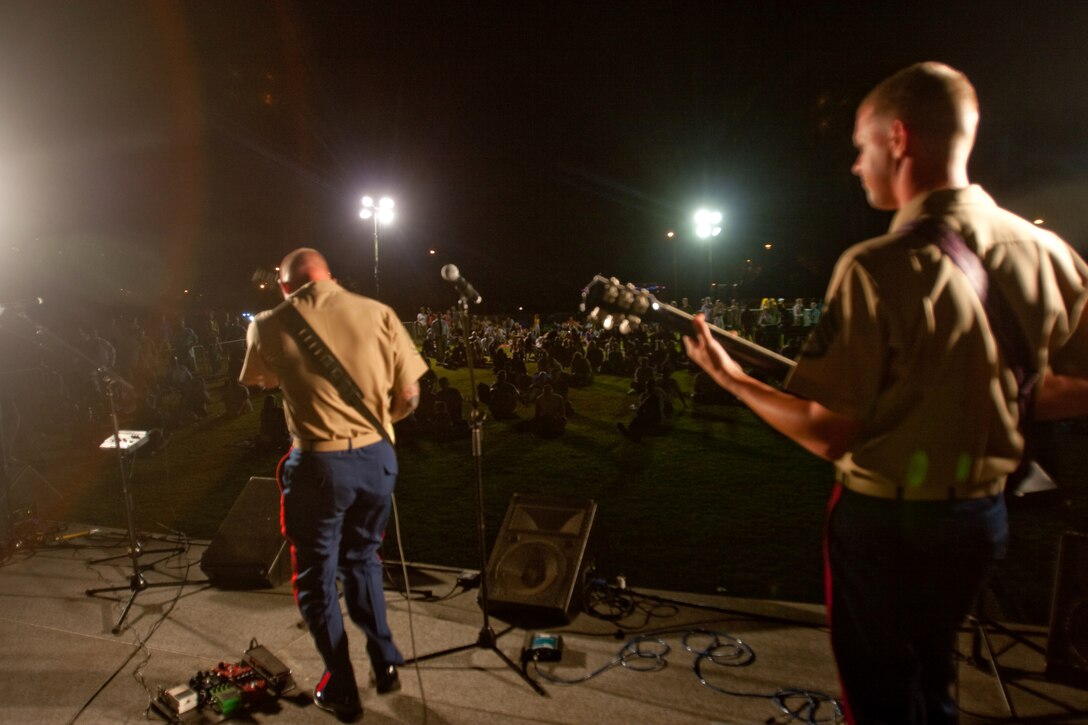 WAIKIKI, Hawaii - Marines with the U.S. Marine Corps Forces, Pacific Rock Band, perform a compilation of rock tunes during the Military Band Mele, May 29, at the Fort DeRussy Parade Grounds, Waikiki, Hawaii. The Mele consisted of pop/ rock performances by Hawaii's Marine, Navy, Air Force and Army bands.