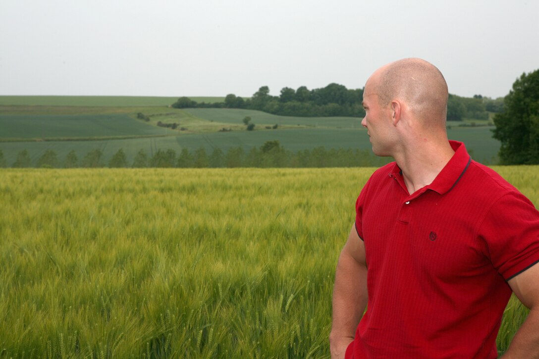 Capt. John Scheler, intelligence officer with Headquarters Company, 5th Marine Regiment and Marrysville, Penn. native,  looks out across the wheat fields at Hill 142 where in June 1918, the Marines of the 5th Regiment took heavy losses to German machine guns. The Marines of both the 5th and 6th Marine Regiments returned to Belleau Wood after 93 years to commemorate the battle their units fought in 93 years ago. During their trip, they conducted a walkthrough study of the attack and walked in the footsteps of their predecessors.