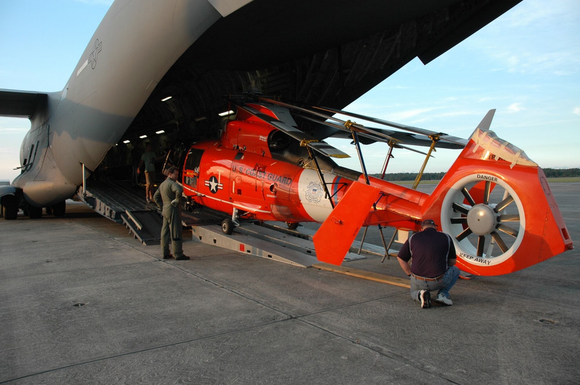 Master Sergeant Phil Johnson, loadmaster 315th Airlift Wing Charleston Air Force Base, S.C. supervised the off load of a U.S Coast Guard Dolphin helicopter May 28 at Cecil Field, Jacksonville Fla. Sergeant Johnson and crew returned the helicopter to the Navy Base for maintenance. (U.S. Air Force Photo/2nd Lt Joe Simms)