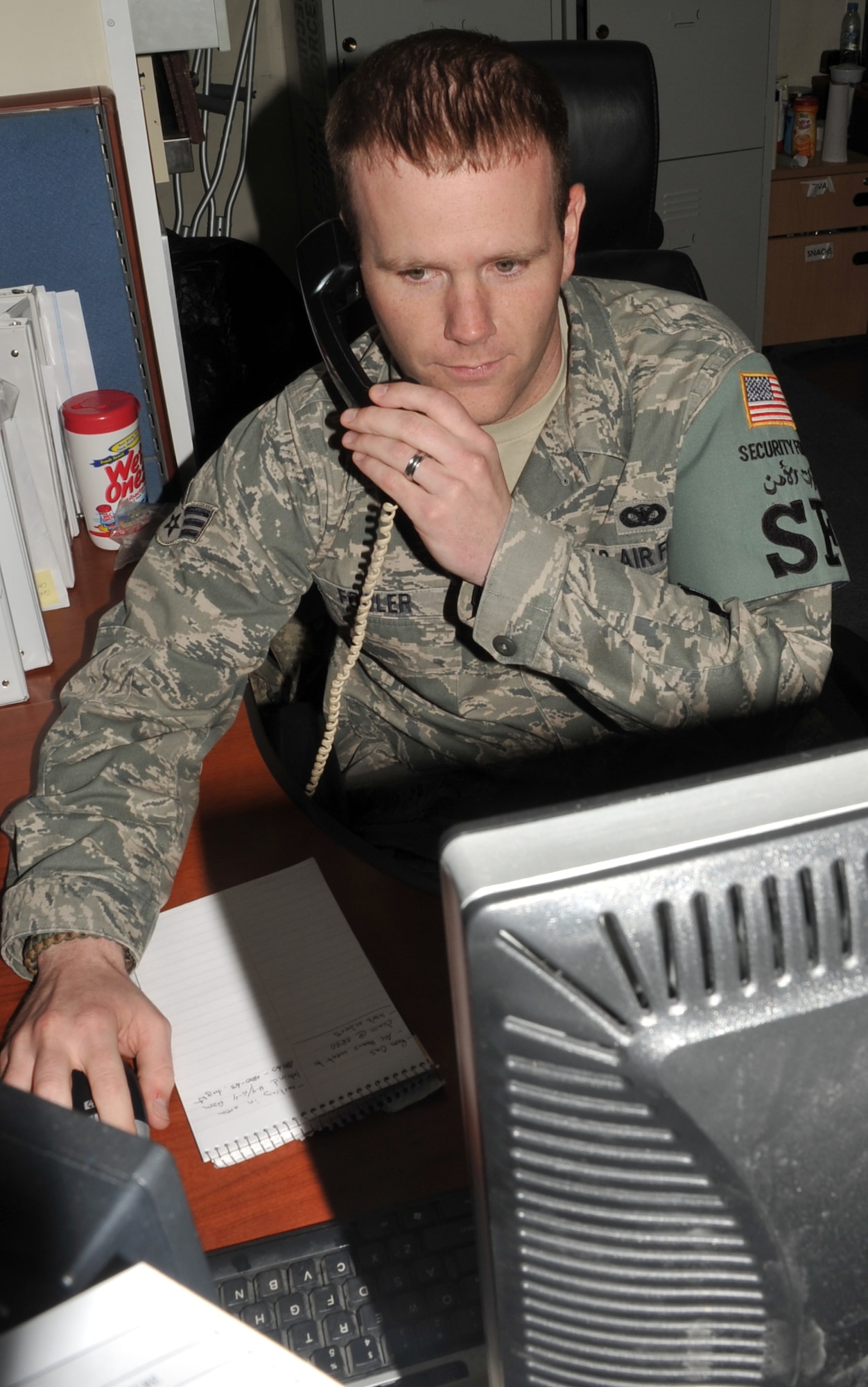 Senior Airman Timothy Fowler, a security forces journeyman with the 380th Expeditionary Security Forces Squadron, works at the security forces desk during operations for the 380th Air Expeditionary Wing at a non-disclosed base in Southwest Asia on May 29, 2010.  Airman Fowler is deployed from the 66th Security Forces Squadron art Hanscom Air Force Base, Mass., and his hometown is Fair Haven, N.J. (U.S. Air Force Photo/Master Sgt. Scott T. Sturkol/Released)