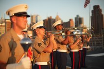NEW YORK -- Marines from Marine Forces Reserve Band play during the Sunset Parade on USS Iwo Jima, May 30, 2010, here. More than 3,000 Marines, Sailors and Coast Guardsmen are in the area participating in community outreach events and equipment demonstrations. This is the 26th year New York City has hosted the sea services for Fleet Week. (Official Marine Corps photo by Sgt. Randall A. Clinton / RELEASED)