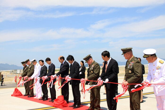 American and Japanese officials cut a ribbon, officially opening the new flight line here to flight operations during a commissioning ceremony May 29. After the ribbon cutting, a Marine F/A-18 Hornet and a Japanese Maritime Self-Defense Force P-3 Orion symbolically closed the old runway with a final take off from it and officially opened the new runway by landing on it.