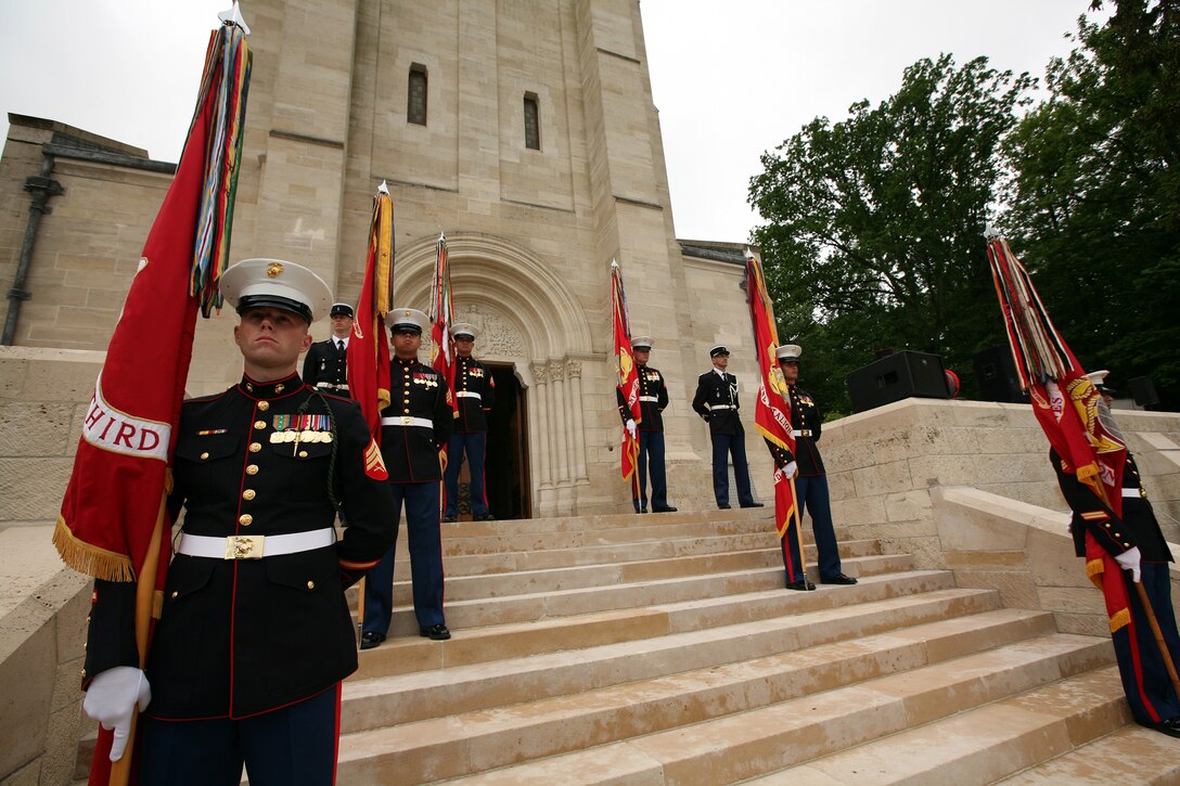The colors sergeants from each battalion of the 5th and 6th Marine Regiments stand on the steps of the Aisne-Marne American Cemetery during a Memorial Day service in honor of the 93rd anniversary of the Battle for Belleau Wood. This year's ceremony marks the first time in 93 years that the Marines of the 5th and 6th Marine Regiments have returned to the battlefield together to honor their fallen comrades. More than 1,800 Marines from the 5th and 6th Regiments lost their lives in the 21-day battle that stopped the last German offensive in 1918.