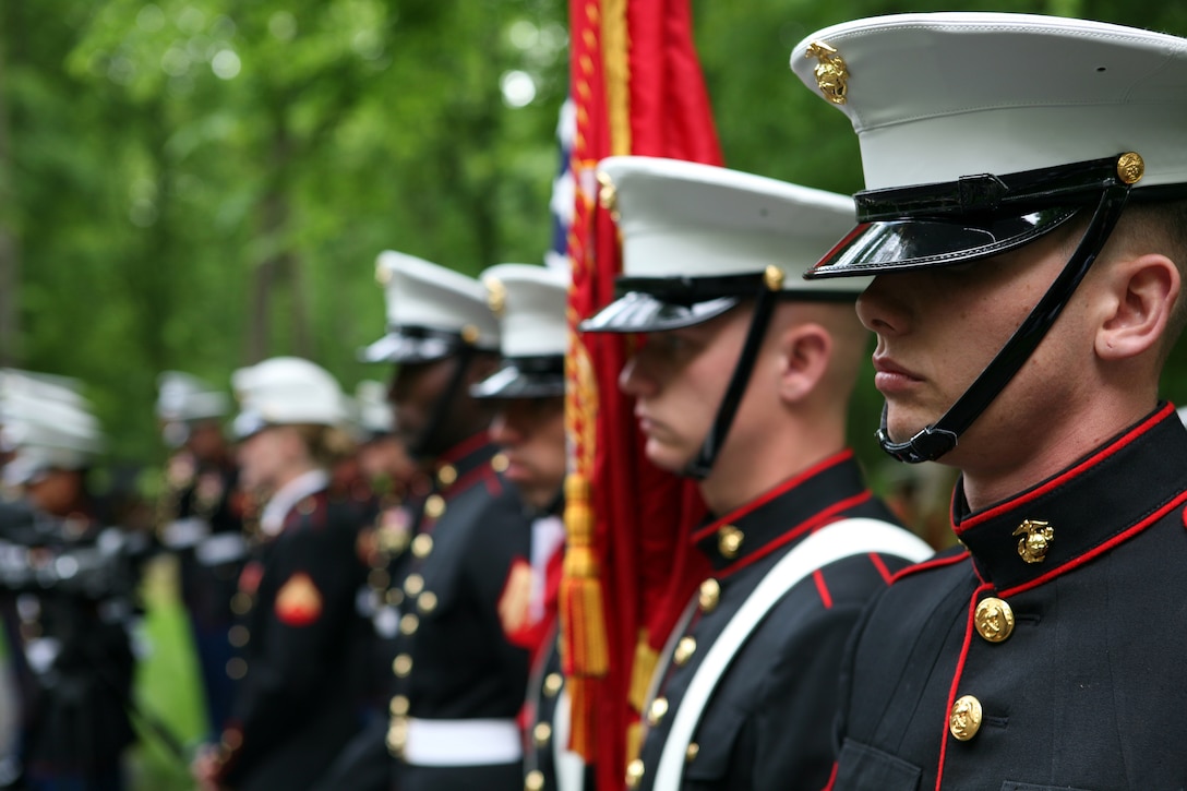 The color guard from Fleet Anti-Terrorism Security Team Rota, Spain stand at the Iron Mike memorial area in the heart of Belleau Wood during a wreath laying ceremony in honor of the more than 1,800 Marines who died in the World War I Battle for Belleau Wood.