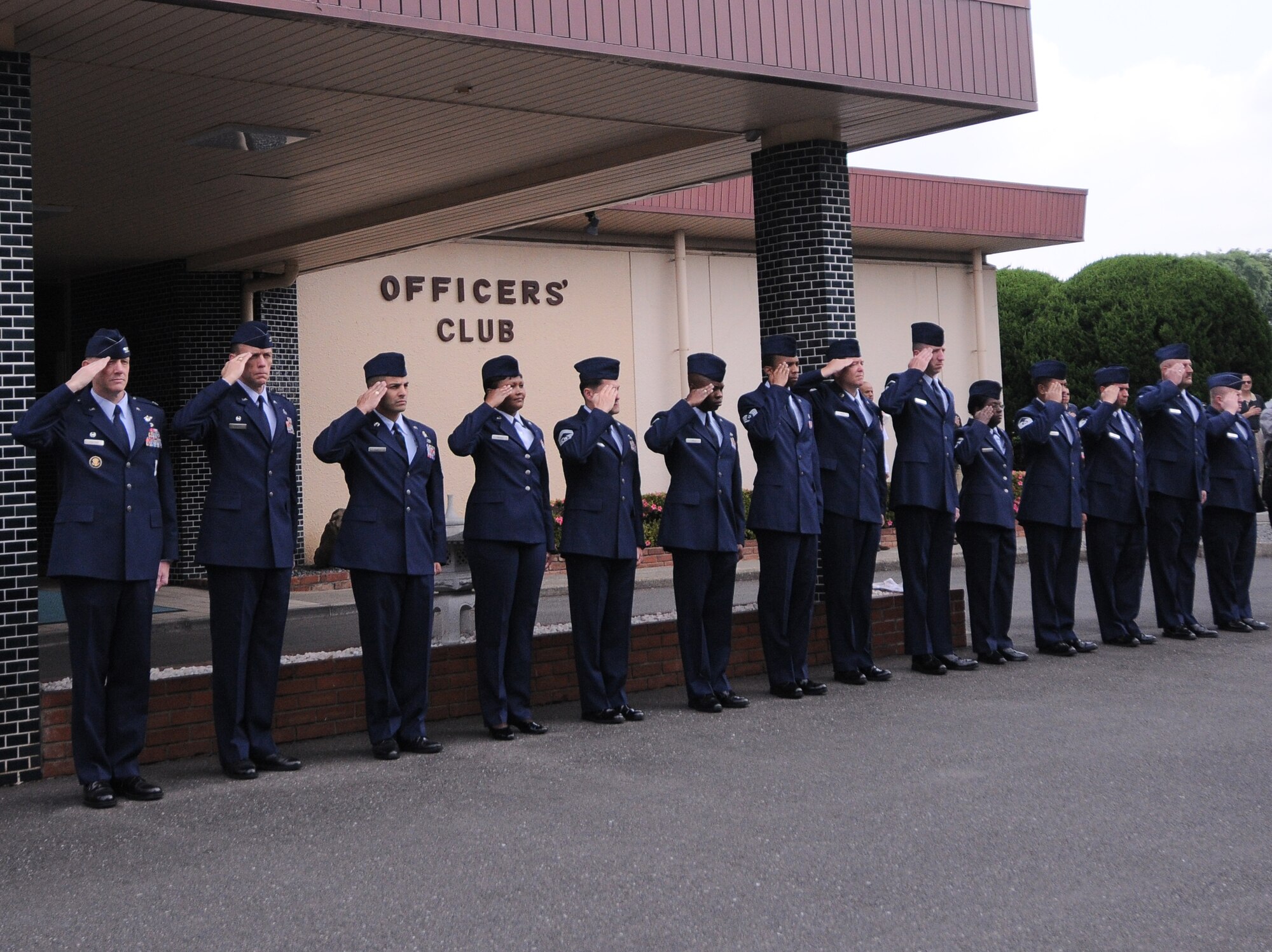 YOKOTA AIR BASE, Japan -- Airmen salute as members of the honor guard posts the colors during the Memorial Day ceremony at the Officer's Club here May 31. Memorial Day is observed on the last Monday of May and was designated to pay tribute to U.S. men and women who died while serving their country. Yokota's American Legion post 2222 holds the ceremony every year to carry on the tradition which first took place at Arlington National Cemetery in 1868. (U.S. Air Force photo/Airman 1st Class Lynsie Lorenz)