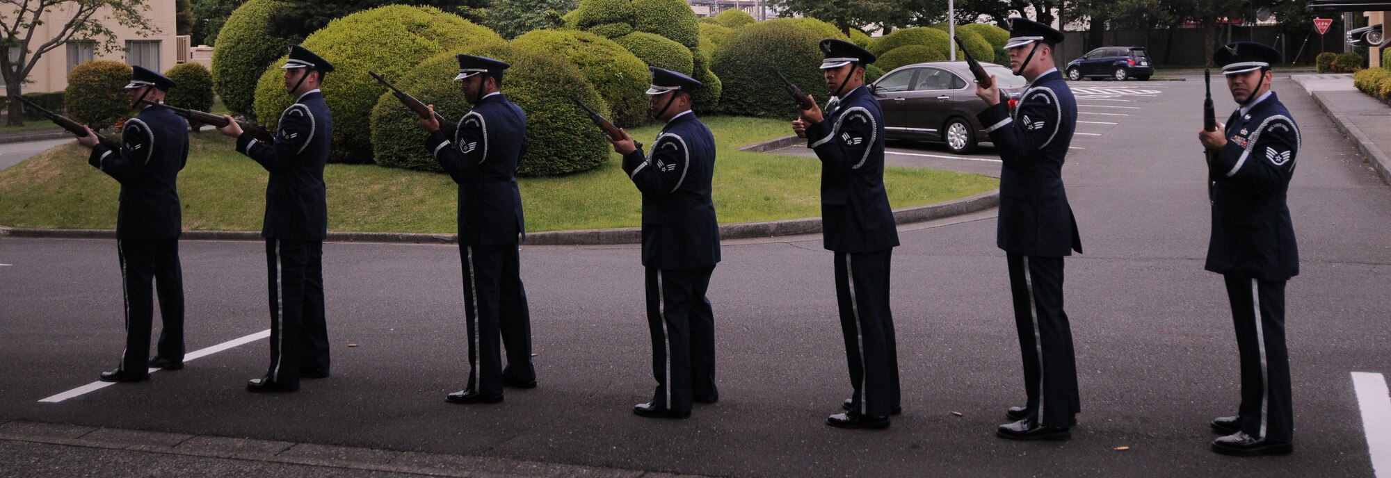 YOKOTA AIR BASE, Japan -- Members of Yokota's Honor Guard perform the 21-gun salute during the Memorial Day ceremony at the Officer's Club here May 31. Memorial Day is observed on the last Monday of May and was designated to pay tribute to U.S. men and women who died while serving their country. Yokota's American Legion post 2222 holds the ceremony every year to carry on the tradition which first took place at Arlington National Cemetery in 1868. (U.S. Air Force photo/Airman 1st Class Lynsie Lorenz)