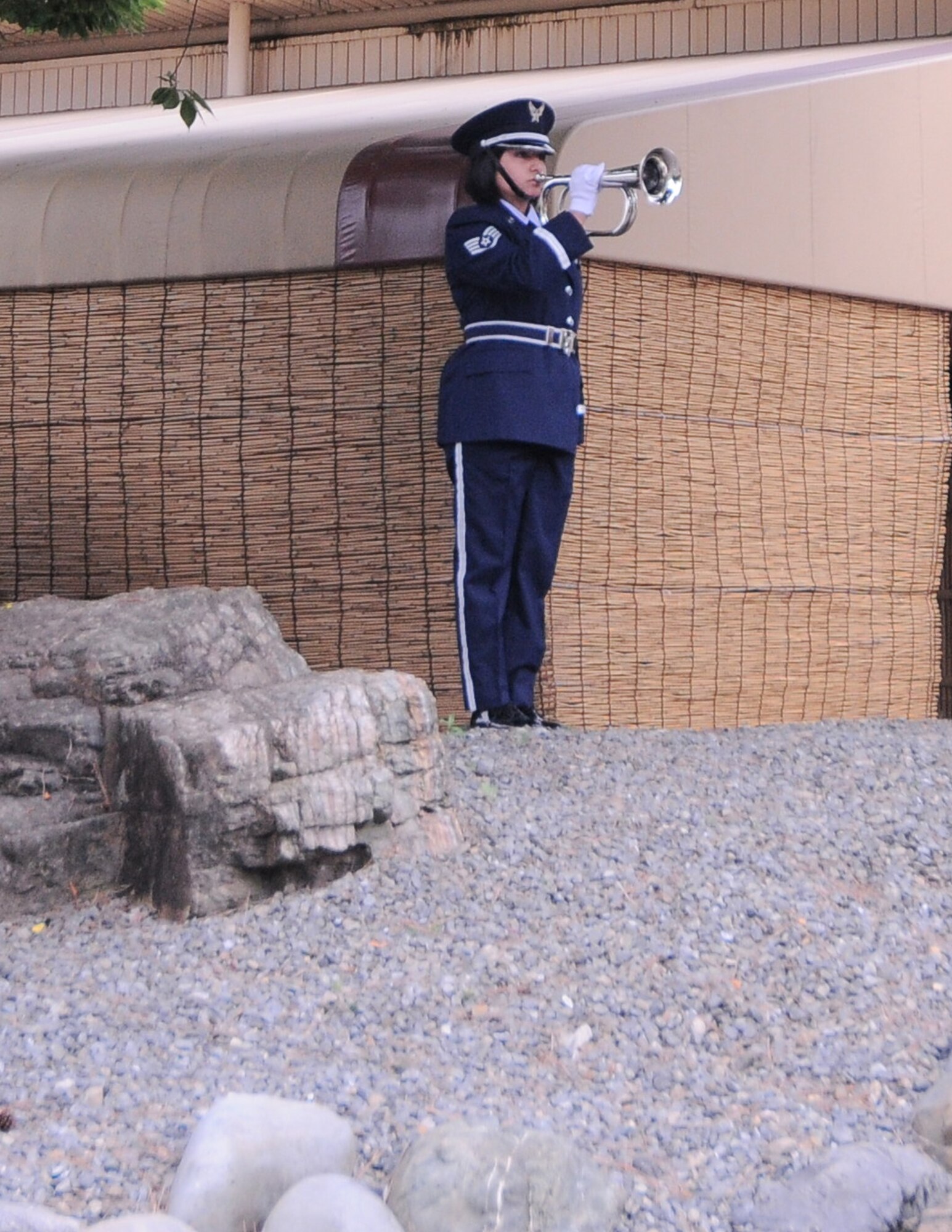 YOKOTA AIR BASE, Japan -- Honor Guard member, Staff Sgt. Elsa Spencer of the 374th Medical Group, plays Taps during the Memorial Day ceremony at the Officer's Club here May 31. Memorial Day is observed on the last Monday of May and was designated to pay tribute to U.S. men and women who died while serving their country. Yokota's American Legion post 2222 holds the ceremony every year to carry on the tradition which first took place at Arlington National Cemetery in 1868. (U.S. Air Force photo/Airman 1st Class Lynsie Lorenz)