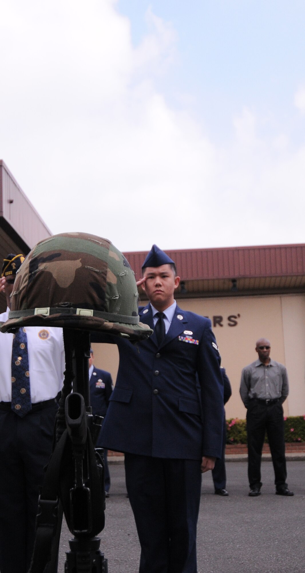 YOKOTA AIR BASE, Japan -- Airman 1st Class Pei-Chi Liu, 374th Maintenance Operations Squadron maintenance management analysis, salutes during the Memorial Day ceremony at the Officer's Club here May 31. Memorial Day is observed on the last Monday of May and was designated to pay tribute to U.S. men and women who died while serving their country. Yokota's American Legion post 2222 holds the ceremony every year to carry on the tradition which first took place at Arlington National Cemetery in 1868. (U.S. Air Force photo/Airman 1st Class Lynsie Lorenz)