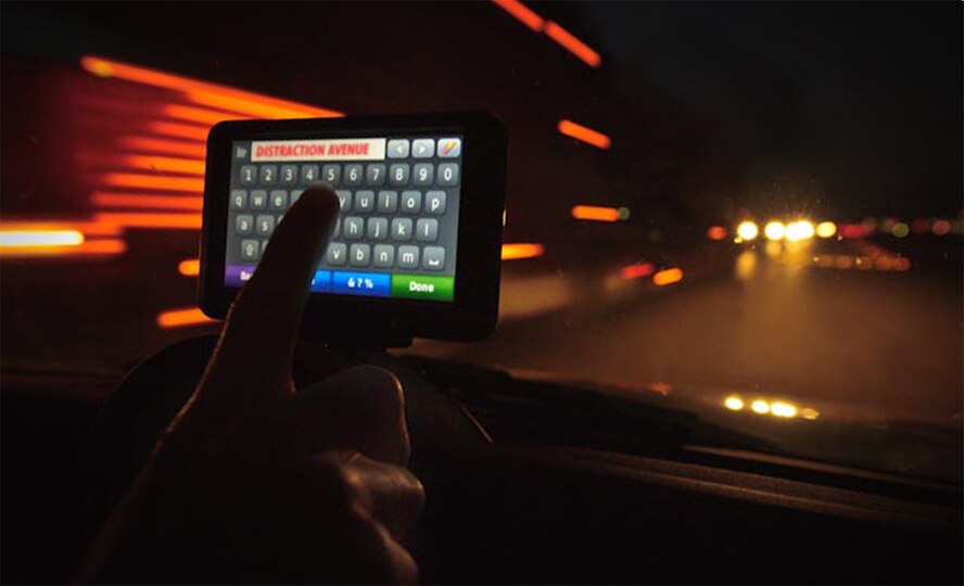 Fiddling with a GPS unit while driving can be a distraction and cause a loss of situational awareness that can lead to a mishap. It's best to set up the unit before you hit the road. (Photo by Tech. Sgt. Samuel Bendet)