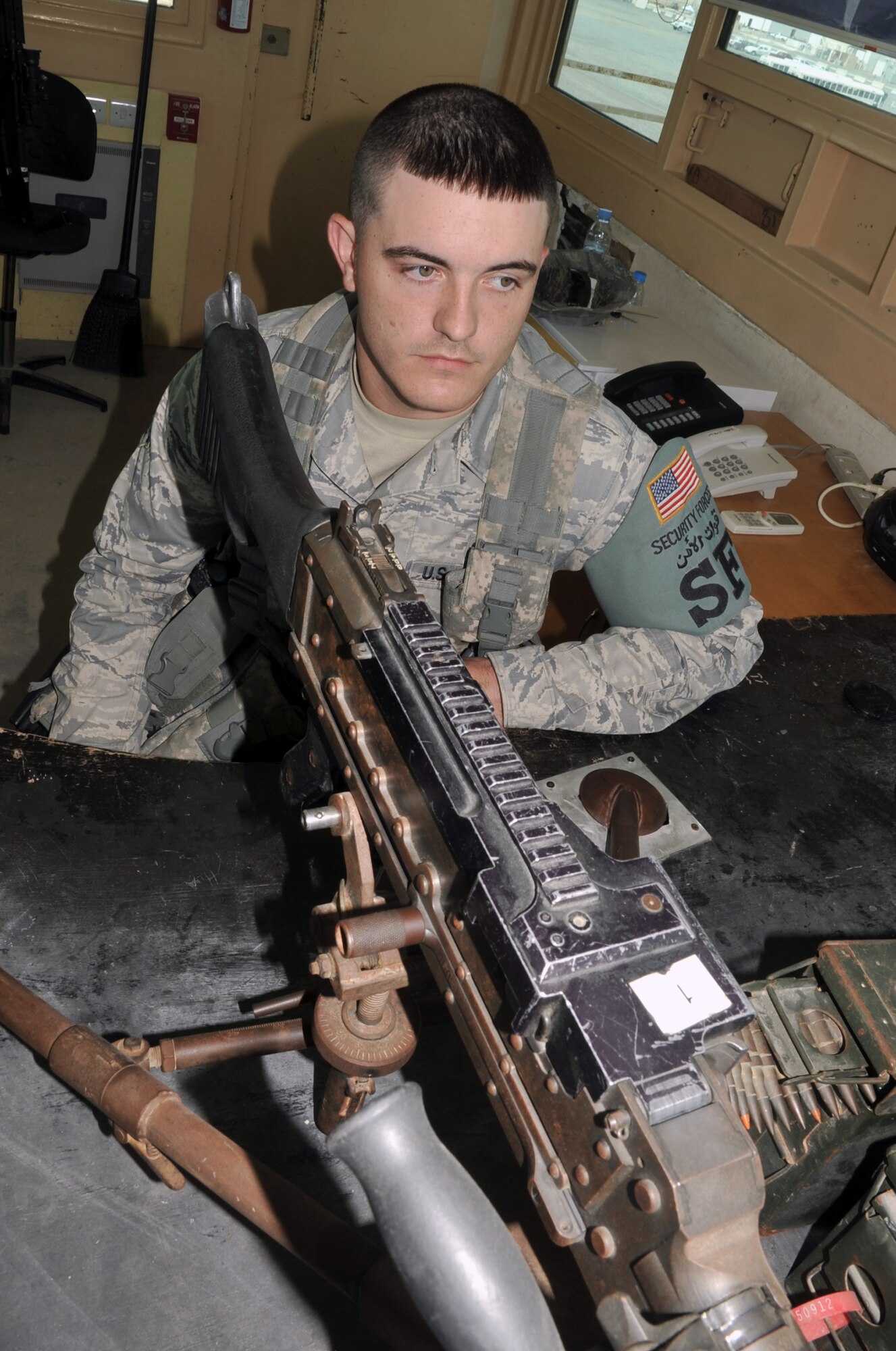 Airman 1st Class Joshua Balentine, a security forces journeyman with the 380th Expeditionary Security Forces Squadron, watches over a machine gun position at a non-disclosed base in Southwest Asia on May 29, 2010. Airman Balentine is deployed from the 96th Security Forces Squadron at Eglin Air Force Base, Fla., and his hometown is Mobile, Ala. (U.S. Air Force Photo/Master Sgt. Scott T. Sturkol/Released)
