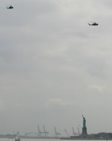 NEW YORK -- An AH-1W Cobra and UH-1N Huey fly past the Statue of Liberty after completing a helicopter raid demonstration, May 29, 2010. More than 3,000 Marines, Sailors and Coast Guardsmen will be in the area participating in community outreach events and equipment demonstrations. This is the 26th year New York City has hosted the sea services for Fleet Week.