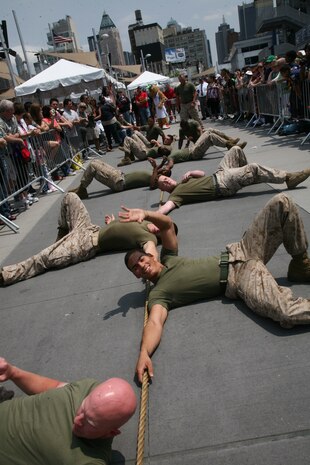 NEW YORK -- Marines from Special Purpose Air Ground Task Force New York prepare to start a tug-of-war contest against a team of sailors.  The Marines competed against a team of sailors in a tug-of-war contest as a part of a week-long sports competition between the service members, May 29 2010.