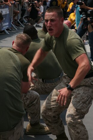 NEW YORK -- A Marine cheers on  cheers on Marines from Special Purpose Air Ground Task Force New York.  The Marines competed against a team of sailors in a tug-of-war contest as a part of a week-long sports competition between the service members, May 29 2010. More than 3,000 Marines, Sailors and Coast Guardsmen will be in the area participating in community outreach events and equipment demonstrations. This is the 26th year New York City has hosted the sea services for Fleet Week.