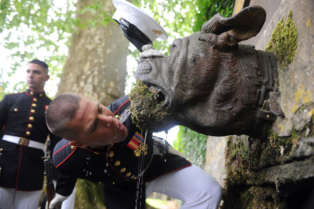 Lance Cpl. Seth H. Capps, a member of the United States Marine Corps Silent Drill Platoon, drinks out of Devil Dog Fountain following the 93rd anniversary of the Battle of Belleau Wood May 30. (Photo By Cpl. Bobby J. Yarbrough)