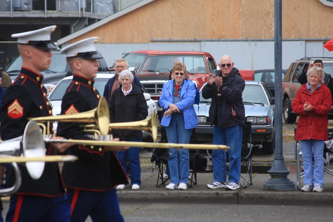 Twenty-one Marines with the Combat Center Band march down Fir Avenue in Reedsport, Ore., past a cheering audience during the annual Memorial Day parade May 31.