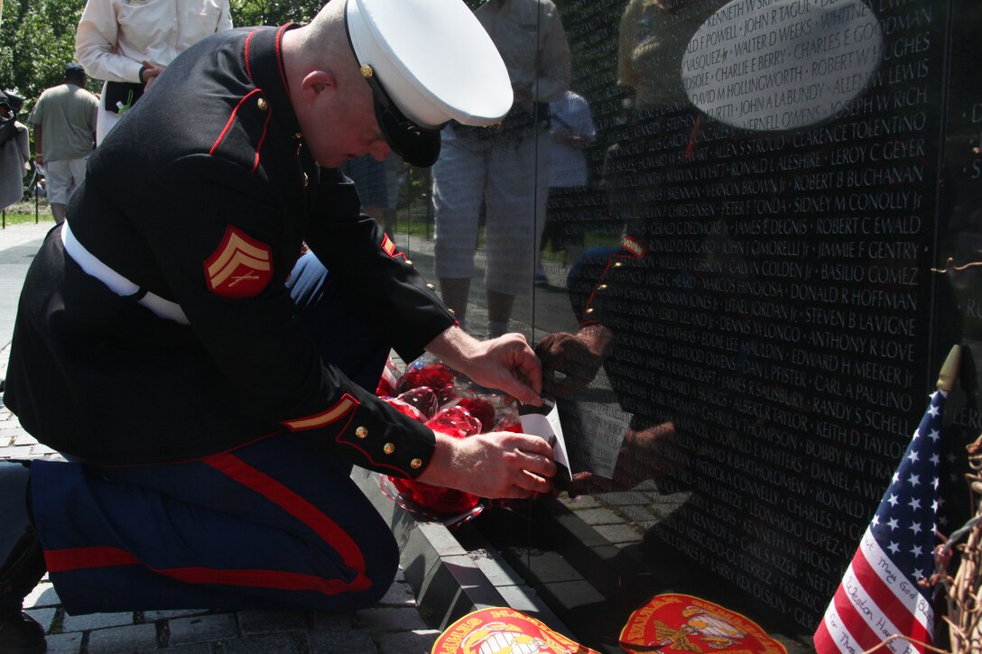 Cpl. John J. Granville, a food service specialist with Marine Corps Mountain Warfare Training Center, Pickel Meadows, Calif., gets a rubbing of his father’s name for the first time May 31, 2010, at the Vietnam Veterans Memorial Wall in Washington. His father, John E. Granville, who served with 1st Battalion, 7th Marine Regiment, in the Vietnam War, died in 2007 from a heart condition that stemmed from injuries he sustained in Vietnam. His name was added to the wall earlier this month.