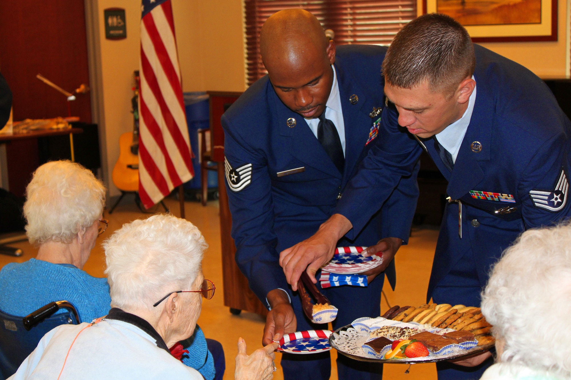 Staff Sgt. Christopher Lavin (right) and Tech. Sgt. Thomas Metcalf pass out food to nursing home residents at a Memorial Day Observance at the VA Nursing Home at Fitzsimons in Aurora, Colo. on May 27.  (U.S. Air Force photo by Tech. Sgt. Scott P. Farley)