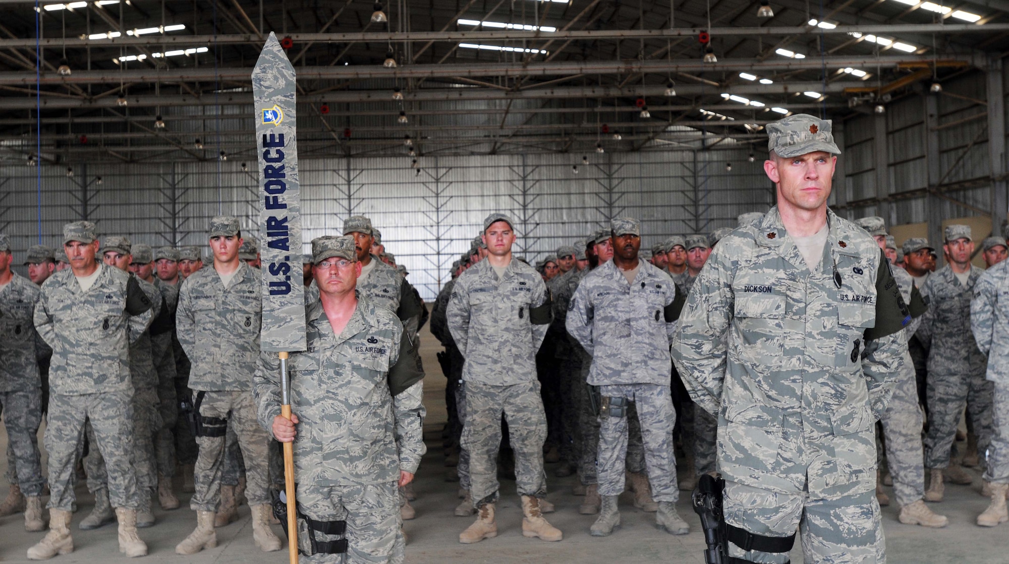 Maj. Sam Dickson, 506th Expeditionary Security Forces Squadron operations officer and Master Sgt. Scott Daigneault, 506th ESFS first sergeant present the 506th ESFS Airmen for the final time at the transfer of authority ceremony at Kirkuk Regional Air Base, Iraq, May 28, 2010.  