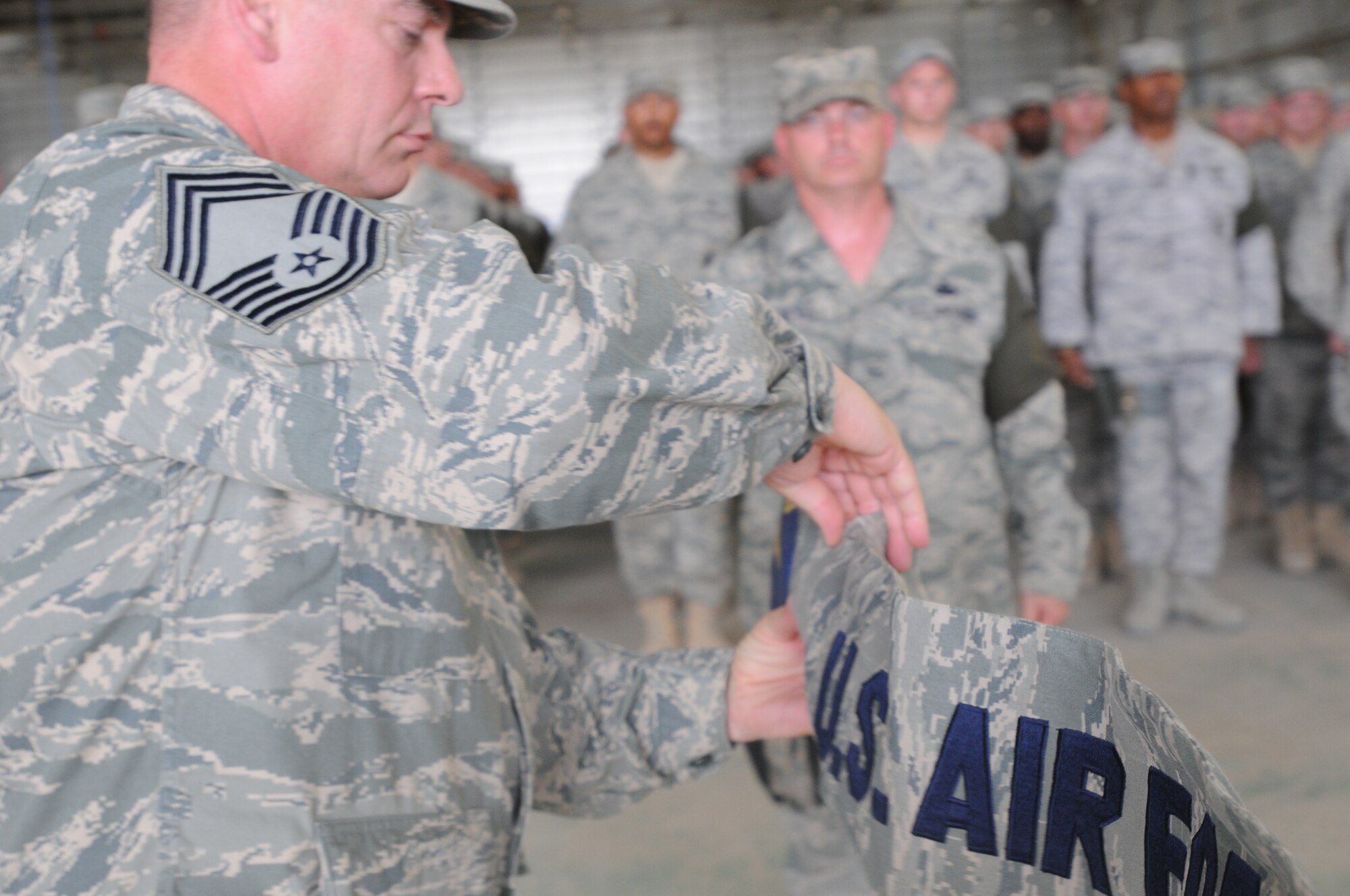 Chief Master Sgt. David Provo, 506th Expeditionary Security Forces Squadron chief enlisted manager cases the 506th ESFS squadron guidon for the final time at Kirkuk Regional Air Base, Iraq during a transfer of authority ceremony May 28, 2010.  The 506th ESFS transferred base security to the Army 1st Special Troops Battalion. In addition to the transfer of authority, the 506th ESFS was officially inactivated.