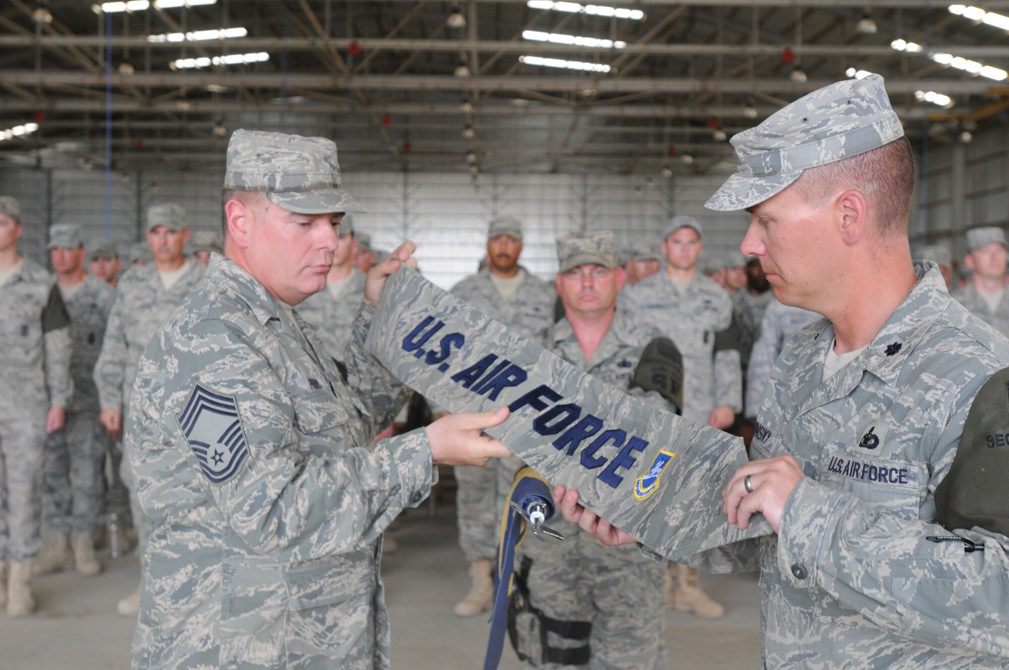 Chief Master Sgt. David Provo, 506th Expeditionary Security Forces Squadron chief enlisted manager and Lt. Col. Theodore Ruminsky, 506th ESFS commander case the 506th ESFS squadron guidon for the final time at Kirkuk Regional Air Base, Iraq during a transfer of authority ceremony May 28, 2010.  The 506th ESFS transferred base security to the Army 1st Special Troops Battalion. In addition to the transfer of authority, the 506th ESFS was officially inactivated.